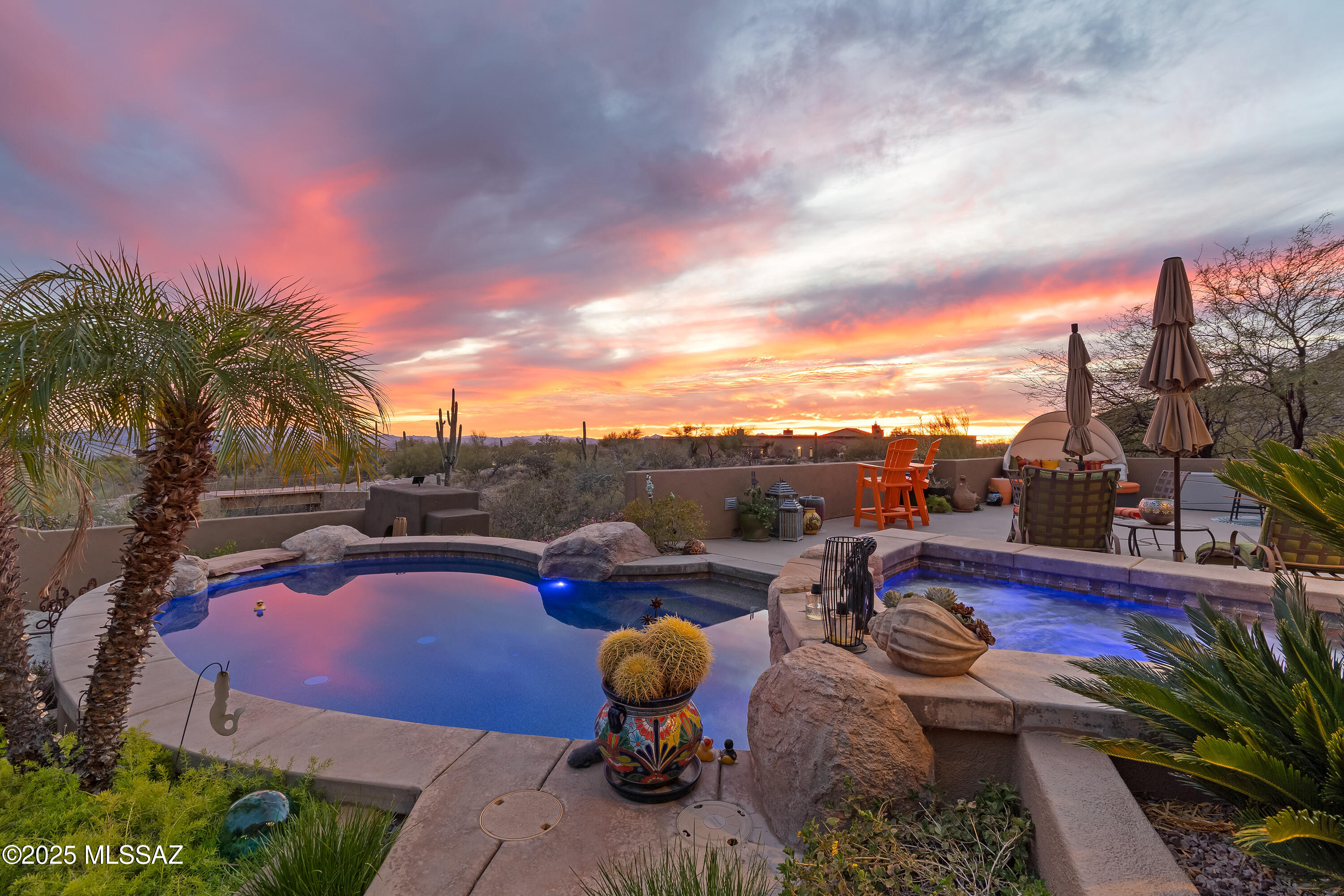 SELLER WILL ENTERTAIN OFFERS BETWEEN $1,999,999.00 - $2,199,999.00 Welcome to an unparalleled Luxury Estate nestled in the heart of the Dove Mountain Tortolita's! Set on 1.81 acres and boasting 3,931 sqft of exquisitely appointed living space, this 4-Bedroom, 4-Bath residence marries Southwest/Hacienda flair with modern sophistication. A graceful winding drive and charming bridge introduce you to a home that captivates at every turn. Perched on a hillside, the property offers breathtaking mountain and city views down the canyon, creating a dramatic backdrop for indoor-outdoor living. The Entertainer's Dream Patio, complete with a an original local artist mural, is designed to host gatherings of 50+ guests, complete with a cascading waterfall, lagoon-style saltwater pool and spa, firepit, and built-in outdoor kitchen.

An additional cozy Outdoor Space, accented by two stylish wind wall shades, invite relaxation and al fresco dining.

Inside, the Chef's Kitchen is a masterpiece featuring a grand butler's pantry - large enough for a full-sized refrigerator and coffee bar, boasts gorgeous cabinetry, lush granite, and premiere appliances.  Multiple rooms are complemented by barnwood accent walls and custom barn doors. While beautiful fireplaces in several rooms enhance the home's inviting ambiance, the modern upgrades including new fixtures, mirrors, paint, and showers underscore the attention to detail throughout.

The Walk-Out Lower Level also offers an infrared-grade sauna with exterior access, perfect for unwinding and two En-Suite Bedrooms and an Elevator, ensuring comfort and convenience for every guest.

This Estate is not just a Home, it's a refined lifestyle experience where every detail has been meticulously crafted for luxury living.