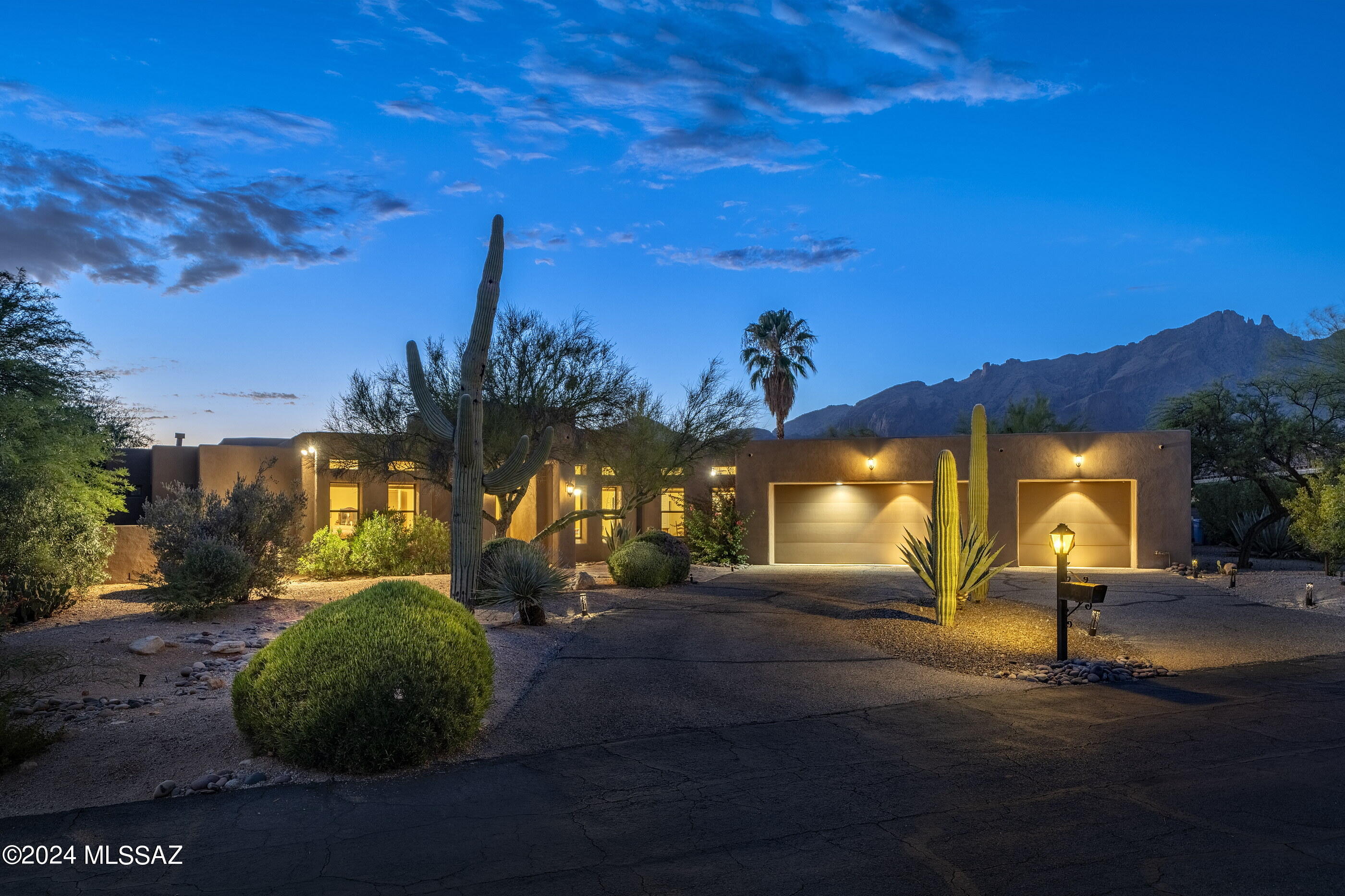 Rare opportunity to own a custom home on a near one-acre homesite with unobstructed mountain views in gated Pontatoc Canyon. Conveniently located in the heart of the Catalina Foothills, this private sanctuary is perched above a large ravine/buffer area creating a wide-open, expansive view & unparalleled privacy. Circular driveway leads to covered entry. The current owners extensively renovated this home.  Walk in to a bright, open space with high ceilings & huge windows that capture mountain views & fill the space with natural light. Great room with gas fireplace flanked with custom built-in shelving & formal dining room with ample space to host large dinner parties. Open kitchen with center island has custom cabinets, granite counters & CONT. ...upgraded, stainless steel appliances, pantry, & breakfast nook with views. Travertine floors throughout. This four bedroom, three bathroom home has a split bedroom floor plan. Each of the 3 bathrooms in the house have been updated.  Step outside into your own private paradise with a covered patio that spans the back of the home. A perfect outdoor space to enjoy the privacy and views. The spacious 3/4-acre lot has a pool & large grassy area. There is an oversized 3-car garage with storage. Both HVAC replaced approximately 2 years ago. Excellent foothills location close to La Paloma Country Club, La Encantada Mall, Hiking Trails, Shopping, & Restaurants. Catalina Foothills District #16 School District. No polybutylene pipes! Current owner repiped the house with PEX pipes in 2008 at time of purchase.