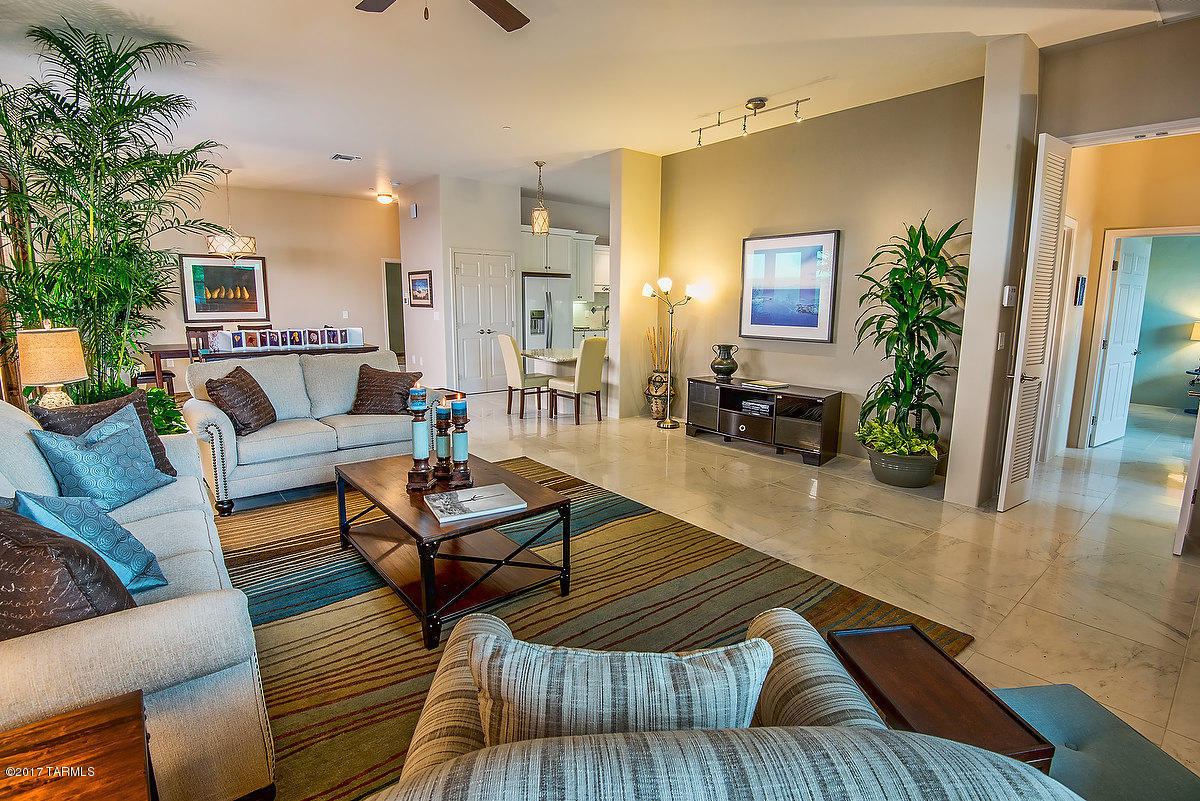 The last new home by the builder of Armory Park del Sol. NET ZERO Energy home has open, split floorplan, 10' high ceilings, huge master bedroom with ensuite and 2 bedroom full bath guest suite. French doors w/sidelights, Energystar appliances, Thermal mass storage construction guarantees low TEP bill. ($20.00 per month!)Recycled, sustainable materials, premium finishes, gourmet kitchen, Handicap accessibility. Alarm, central vacuum, home sprinkler system, Electric car charger, water harvesting cistern, Solar hot water heater, tankless water heater. 3 car garage, 3rd bay has 1/2 bath & mini split for heating & cooling. Gladiator storage system in garage included in sale. Owner is a Licensed RE Broker in AZ.