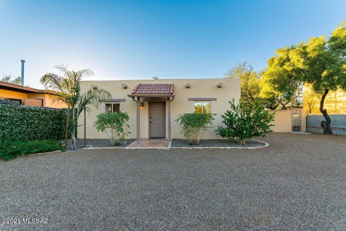 Move-in ready centrally located home w/ a guest home. Main home features 3 bed/2 bath, 1,413 sq. ft., family room, dining area, exposed beam ceilings, tile floors throughout, electric fireplace & much more. Kitchen has slate appliances, custom white cabinets & double SS sink. Homes have separate yards & private entries. Guest home has 1 bed/1bath, family room, eat-in dining area & separate laundry room. Main home has AC & guest home has Evap cooling. Main home is rented for $1,500/mo , guest home $800/mo. or live in one and rent the guest house Great location near U of A, shopping, restaurants, I-10 access & much more.