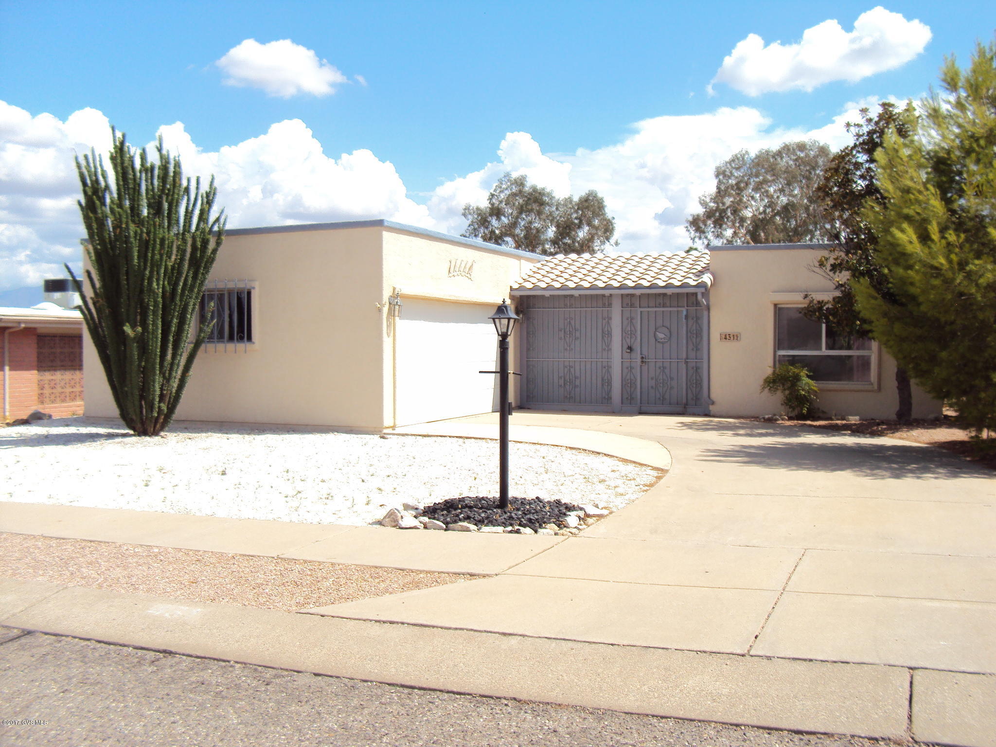 Two bedrooms and den plus a family area as well as formal living room. Updated kitchen. Both bathrooms have tubs and double sinks. Lots of storage and closet space. Double garage has a workshop and separate storage room. Rear of home has security blinds. The large lot has covered patio, citrus trees and room for more than one garden.