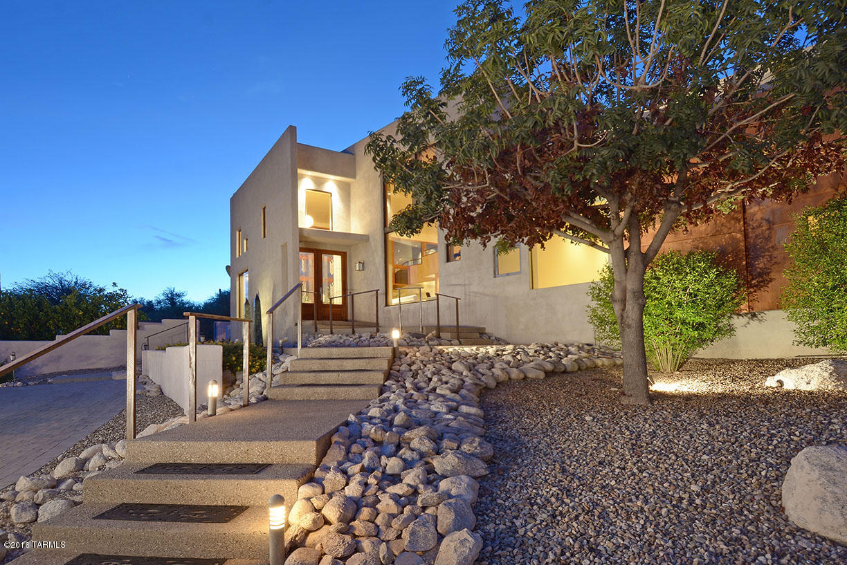 Located in the world renowned Canyon Ranch health and Spa fitness resort.  This beautiful estate sits upon a 3/4 acre hilltop lot offering an abundance of views from custom picture windows throughout.  Plank white ash wood floors, high ceilings, granite kitchen counters/stainless appliances, and loft style master bedroom construction are all a part of the architecture and character of the home.  Complete with elevator, versatile room plan, ensuite guest bedroom/baths, two car garage, and an incredible amount of storage options  round out the functionality.