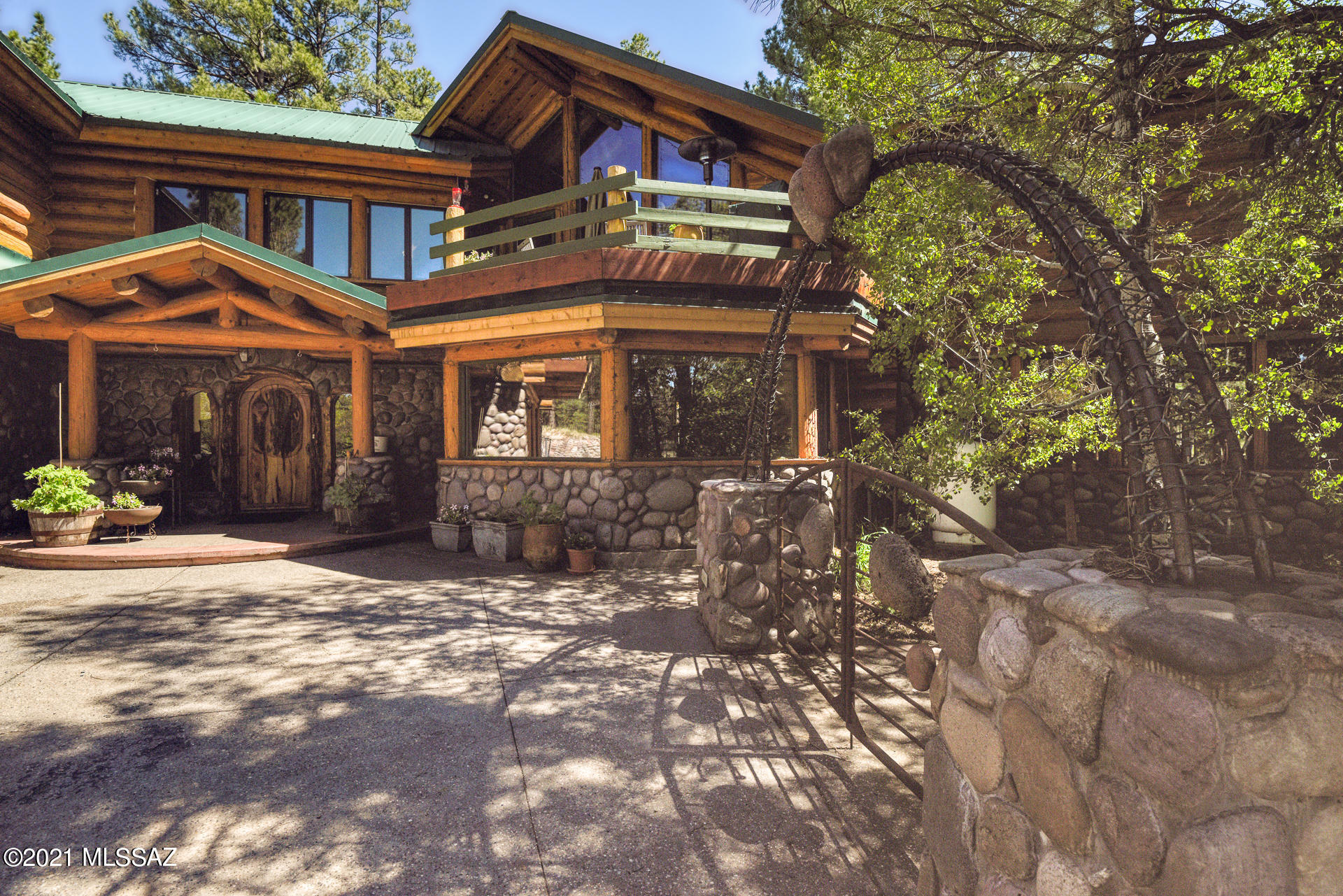 Welcome to Paradise at 7,000 Ft. The Estate at North Ranch boasts over 12 Acres in a gated private community with only 3 other homes, surrounded by National Forest Service. This rare property features all paved, easy access, just 14 minutes from downtown Flagstaff. This heritage log homestead at over 6,000 sq. ft. with 5 bedrooms, 4.5 baths, 3 car garage plus a workshop has room for everyone and all your toys. Entertain your family and friends in the spacious upgraded kitchen, on one of the multiple decks or patio's or hang out at the bar or one of the two game rooms. Bright and open with walls of windows and tons of special custom stone and log work. The extensive outdoor space at this property is simply stunning with a deep water well, two Koi ponds with a stream between them makes for a wonderful water feature, huge fenced yard, raised bed garden and there's even a tree house. Schedule your private showing today-available to tour on Thursdays or Sundays.