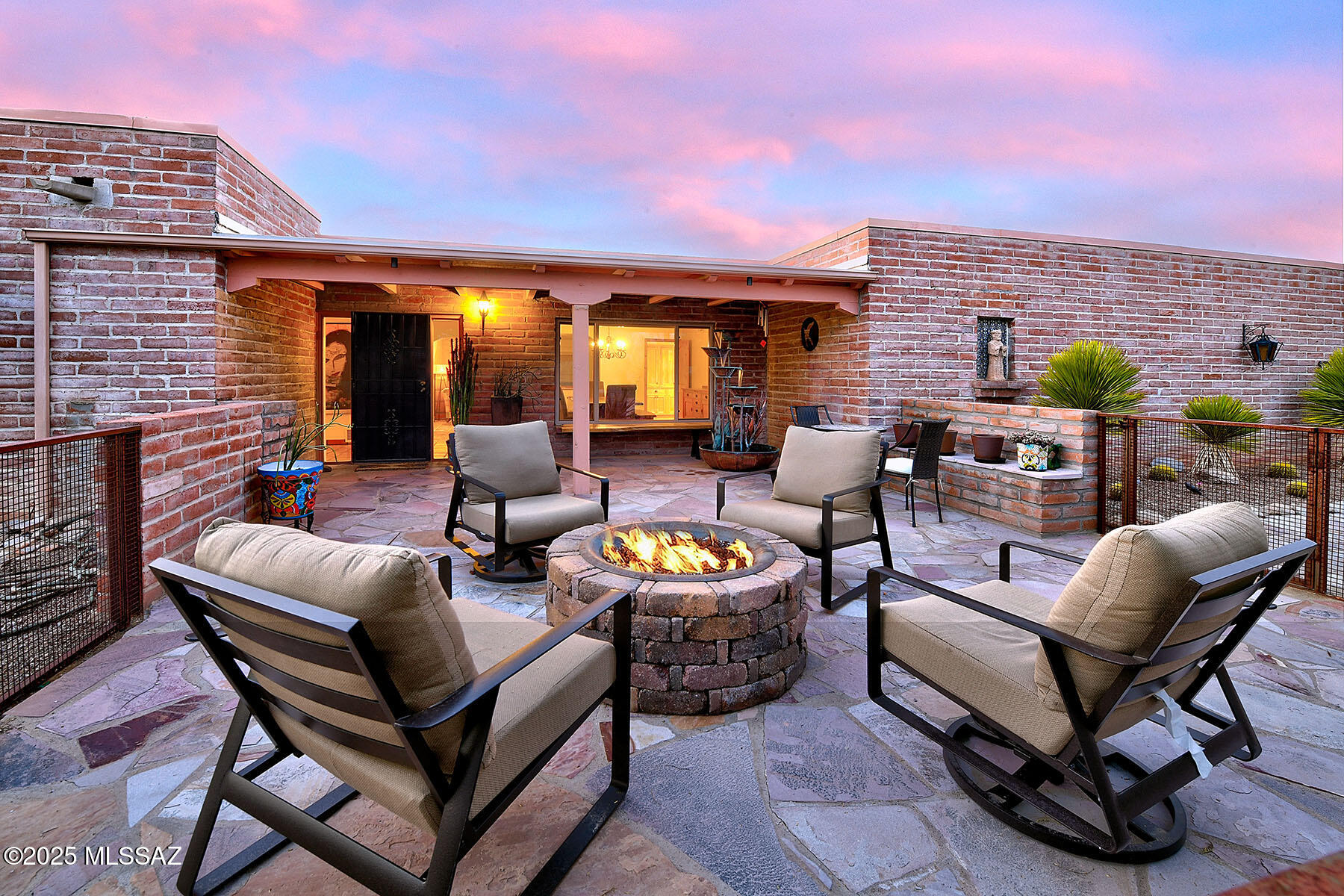 Located high on a tranquil 1.6-acre cul-de-sac lot, this stunning 3-bedroom, 2-bathroom, 2,275 sq. ft. burnt adobe territorial style home seamlessly blends timeless charm with contemporary upgrades. From the moment you step through the inviting front courtyard, you'll be captivated by the warmth and character of this beautifully updated residence.  The thoughtfully remodeled kitchen features all new cabinetry, quartz countertops, all new plumbing fixtures and picture window facing the mountains.  Extensive updates throughout the home including remodeled baths enhance its classic appeal, while the charming beehive fireplace adds a cozy touch. Multiple living areas provide versatility and comfort, all framed by breathtaking north-facing views of the Catalina Mountains. The backyard, surrounded by lush Sonoran Desert vegetation, offers both privacy and a serene connection to nature, with ample space for a pool. This meticulously maintained Tucson home harmoniously balances old-world allure with modern conveniences, presenting a rare opportunity to own a special slice of the coveted Catalina Foothills.