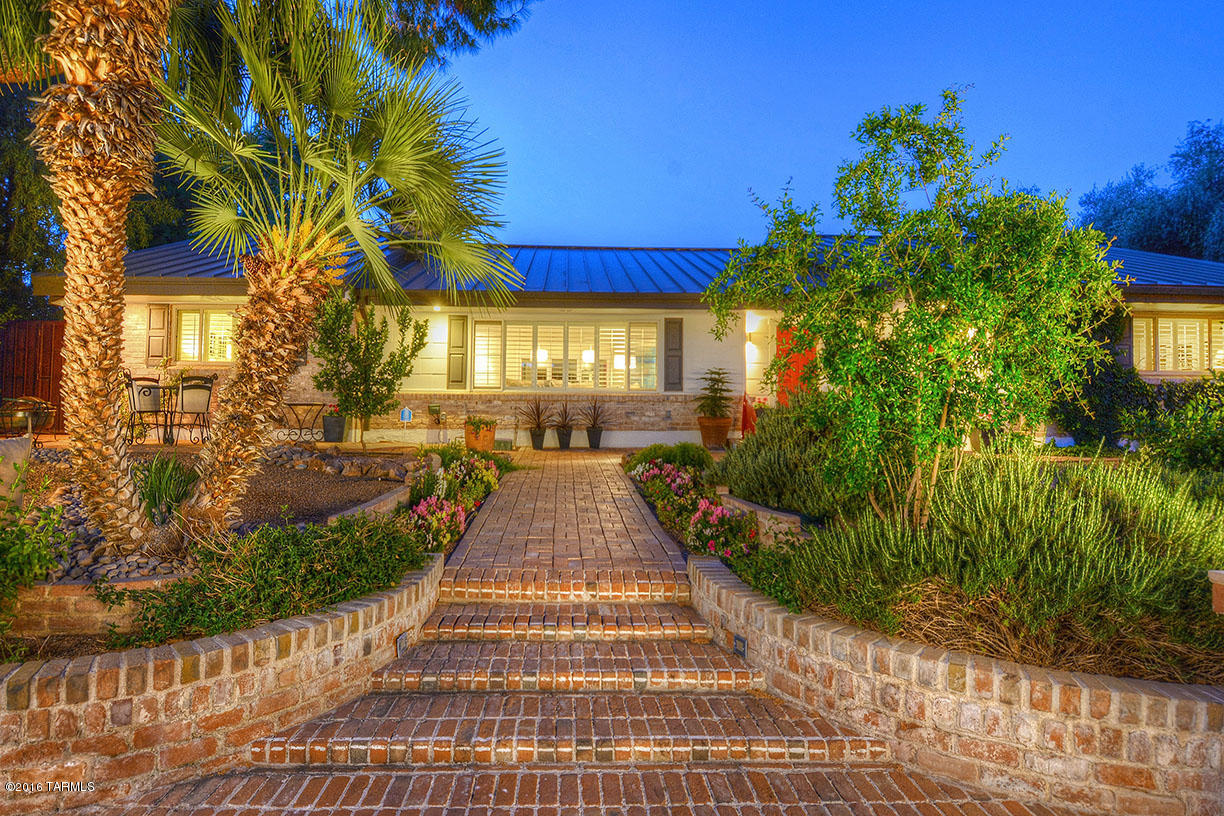 Sam Hughes 1950’s Modern on coveted 3rd  Street just two blocks from the U of A! Double Brick, Raised Seamless Metal Roof, Uniquely Landscaped & Impeccably restored & renovated, new flooring throughout, remodeled kitchen, beaded inset Decora self-closing cabinets, Carrera marble island with a breakfast bar, Thermador SS appliances, 145 bottle sub-zero wine fridge, whole house water softener, Reverse Osmosis,  4 Master Suites, 4th suite is separate guest quarters, Split bedrooms, Steam-room shower, Two person spa tub, 16’ glass accordion door opens to lush gardens canopied by large trees, surrounded by flower gardens, fruit trees and a stunning garden centerpiece koi/fountain/pond, covered patios, Walled & extremely private, Reclaimed water, 2 car garage plus off St. parking.