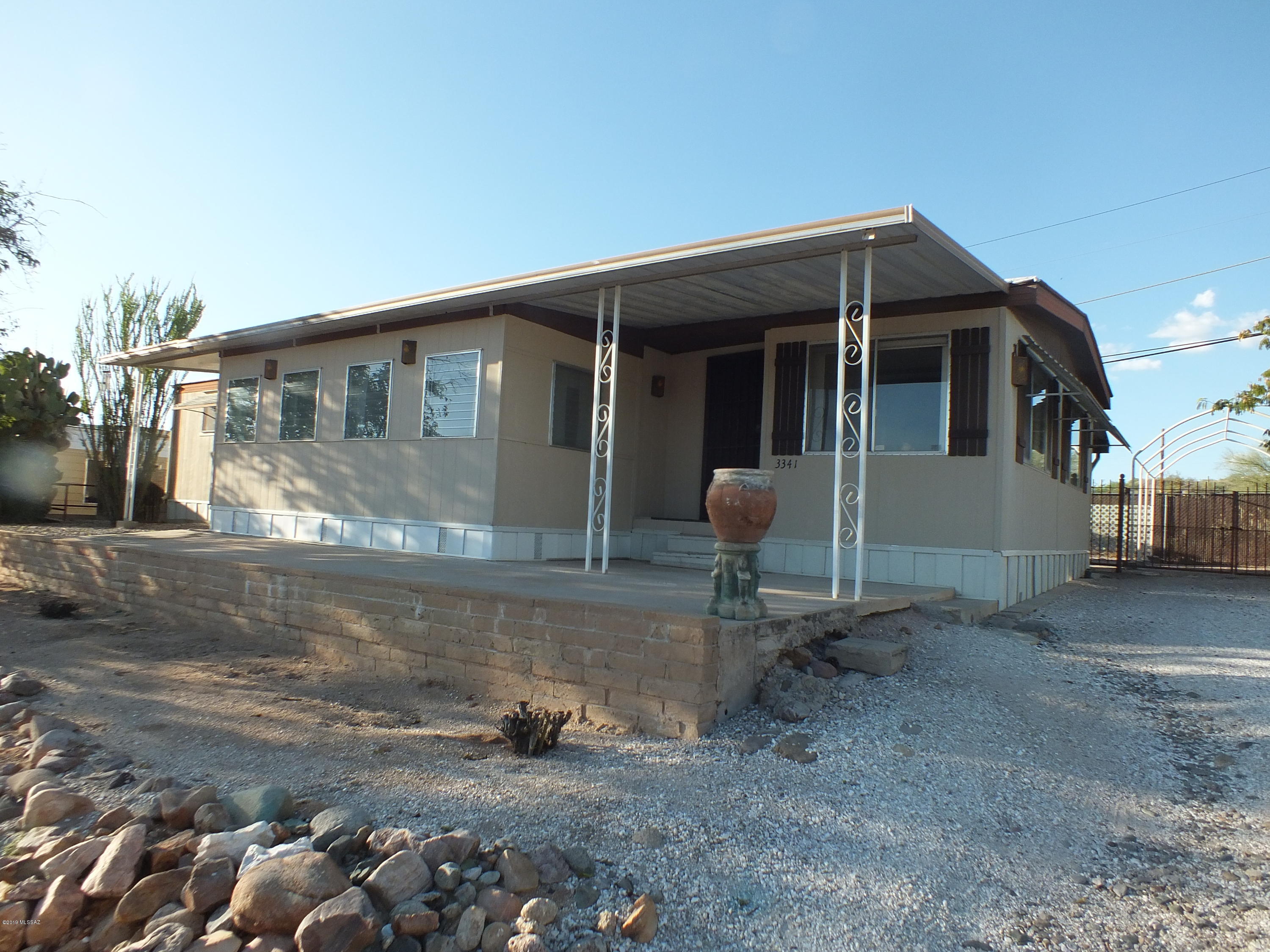 Priced to sell 1488 square foot manufacture home with 200 sq. ft. addition. Home includes large living room and kitchen areas as well as large office/family room off of kitchen. There are 2 bedrooms and 2 baths. Backyard is fenced and includes a covered patio, 480 square foot storage/garage with electricity. The metal carport is there just needs a new canopy. Heat is approximately 2-3 year old.