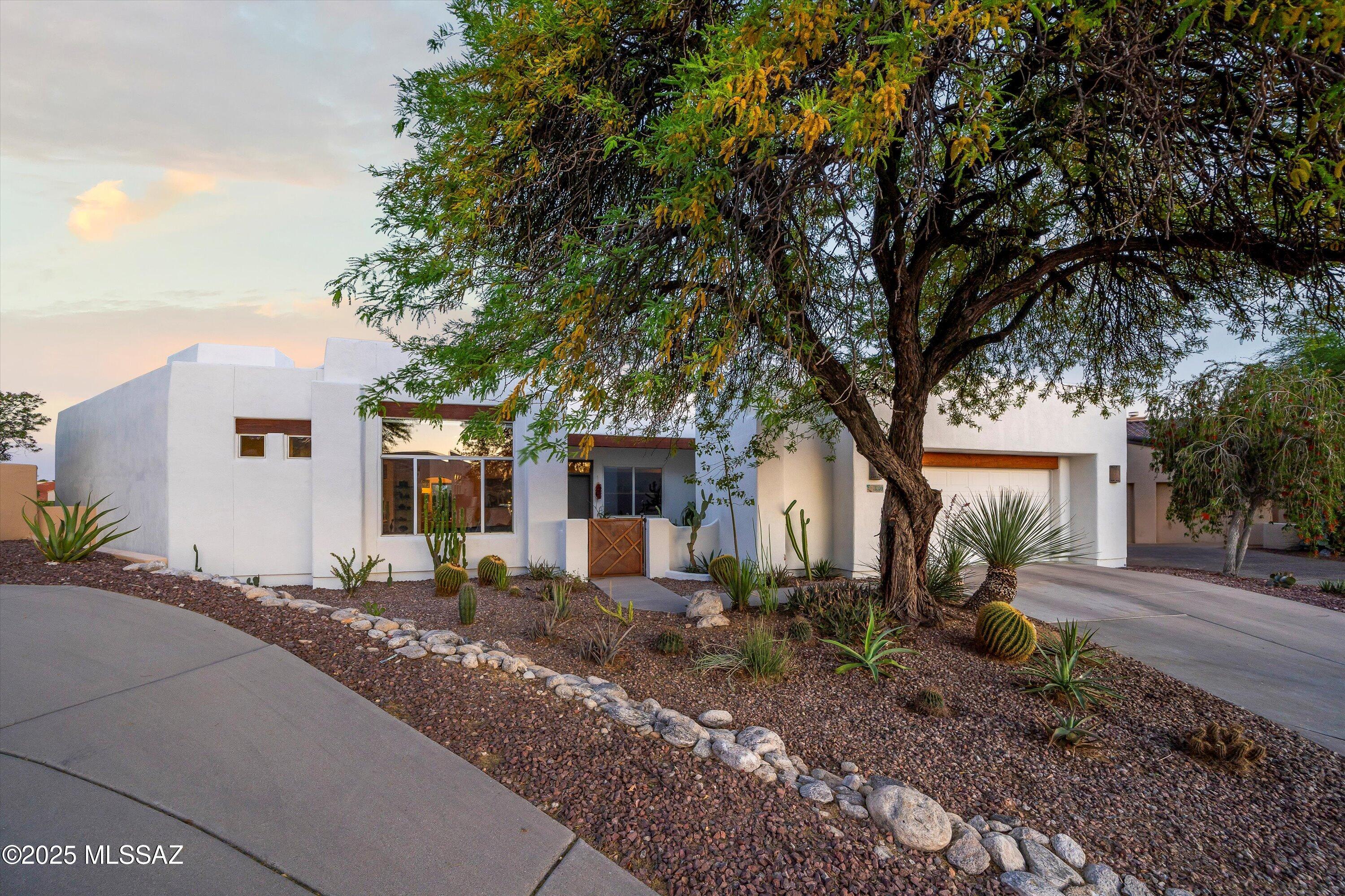 Now $814,000! European-inspired design meets Southwest comfort. Eco-conscious touches define this 4BD/3BA retreat. Artisan beech cabinetry by a local craftsman, Richlite countertops (to be refinished), concrete overlay floors, and solar panels offer both style and sustainability. The flex room includes a Murphy bed with a bath just steps away—ideal for guests, work, or creative use.   Enjoy golden sunsets over the mountains, unwind in the backyard spa, and charge your vehicle with ease thanks to the EV-ready garage. Sellers welcome thoughtful offers from buyers who see the potential. Fantastic location! Minutes to restaurants, shopping and easy drive to UA and downtown.
