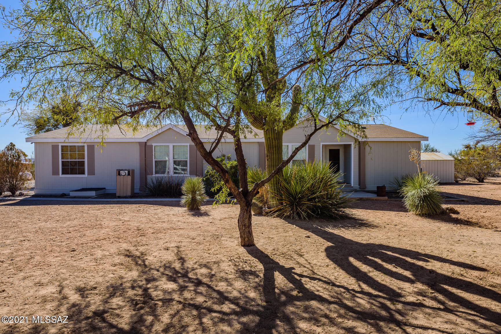 Manufactured Home in Vail with plenty of acreage & privacy! This unique property boasts 4 bedrooms, 2 complete bathrooms, 5 carport spaces, 4.94 acres of land, storage shed, AND it is located in the highly desired Vail school district. This property is within walking distance to Ocotillo Ridge Elementary School and Rancho Del Lago Community Park which includes a tennis court, soccer field, playground, ramadas, & dog park!! This formal model home also includes a large cozy living room and separate dining area. Kitchen highlights: SS appliances, refrigerator, gas range, microwave, island, breakfast bar & pantry. Master suite includes large soaking tub, separate shower and a dual vanity. Home is very energy efficient. Average monthly water bill is under $30, average monthly gas bill is $33 ($50 yearly fee). Copies of recent utility bills to be provided upon request. Home also boasts vaulted ceilings, ceiling fans, & is prewired for surround sound. Backyard is landscaped and includes plenty of trees for the nature lovers. Beautiful sunset views and lot has the potential to be subdivided. Main access to home is a dirt road.