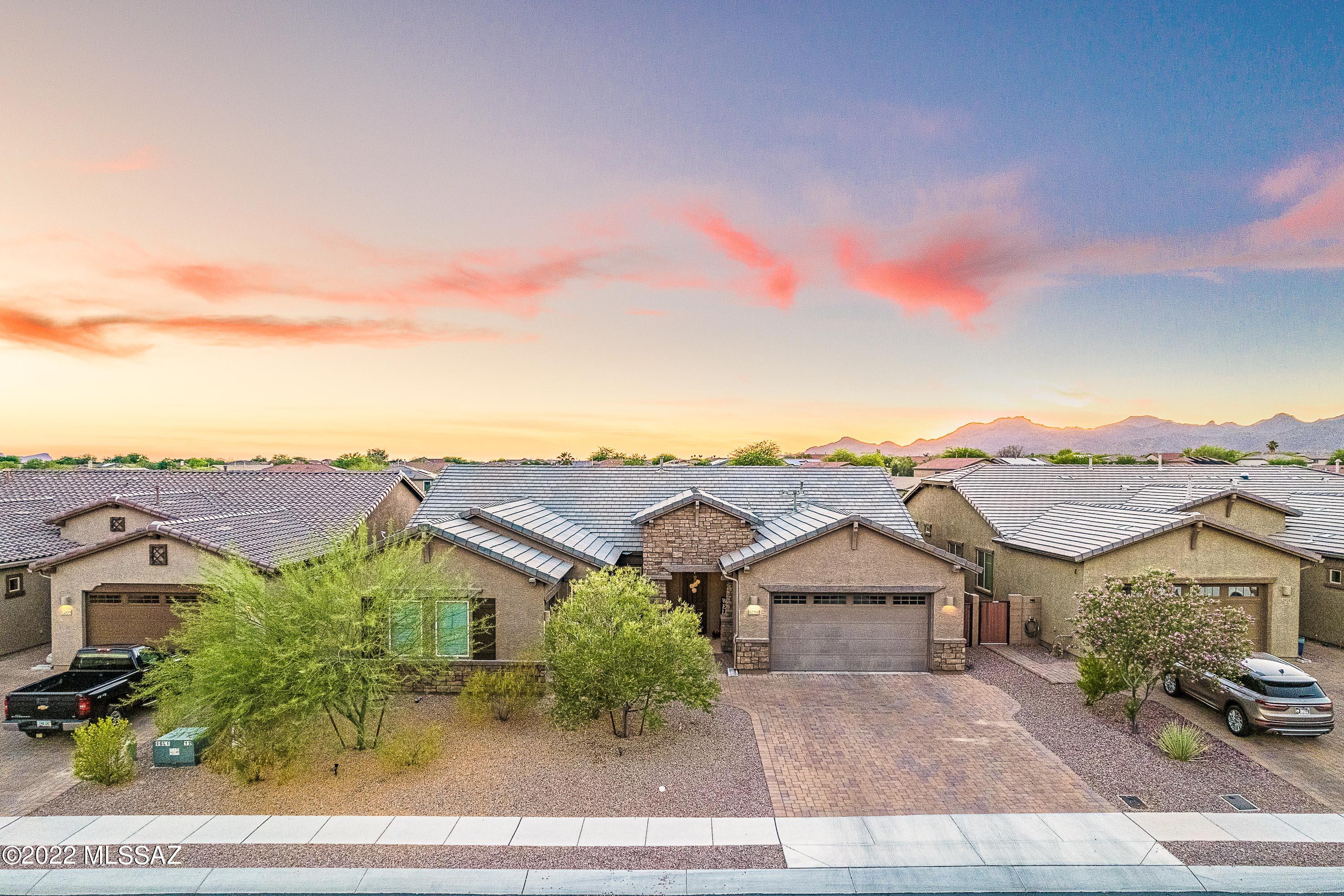 Welcome to the finest in Oro Valley living. A beautiful home located on a premium elevated lot in Eagles Summit in Rancho Vistoso. Whether you like to entertain, host guests, or enjoy private time you will find that this home hits all the marks! Walk into an open concept floor plan including multiple upgrades with a gourmet chef's kitchen with a commercial grade 6-burner gas range, wine fridge, walk in pantry and much more. The backyard sunset and mountain views are accompanied by a gorgeous Pebble-Tec heated pool, elevated gas fireplace, and observation deck with 360' views.
