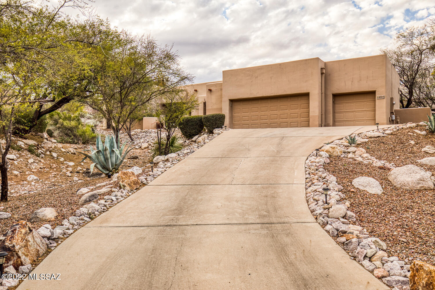Located in the highly desired Ventana Ridge gated community, this masterfully designed home creates the perfect setting for everyday living and entertaining. The main living areas are flooded with natural light from the walls of windows throughout the home, accentuating the gorgeous wooden beams and giving visual access to the beautiful desert that surrounds. The primary suite is situated in its own wing of the house apart from the great room and guest suites and boasts a large walk in closet, garden tub, walk in shower, and direct access to its own backyard patio area. Beautifully designed great room allows for easy entertaining as you look out to the Catalinas, and the oversized three car garage is an added bonus. Home is located close to Sabino Canyon, Ventana, and much more.