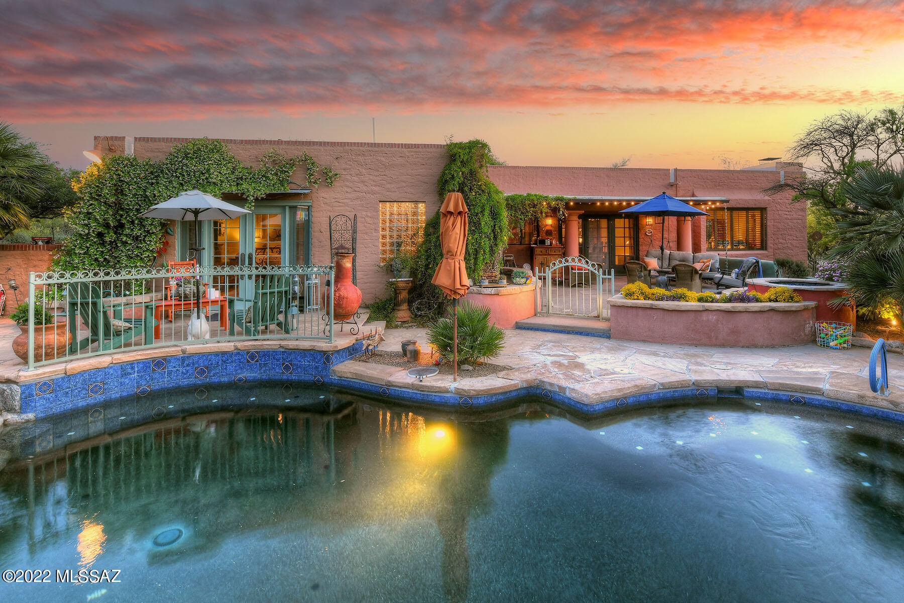 Private gate & paver driveway lead to this stunning burnt adobe with gorgeous mountain views. La Quinta built masterpiece nestled on 1 acre in Catalina Foothills Estates 8. Custom paint, refurbished woodwork & doors throughout, high ceilings & signature corbels create a feeling of warmth. The foyer opens into a dining area with a one-of-a-kind custom table & chairs (that conveys) next to the sunken living room with picture window, tile floors, plantation shutters, converted gas fireplace & vintage chandelier. Primary ensuite looks out onto the backyard through French doors with pewter hardware while the bath features concrete counters, purple glass basin, heated floors & a six head steam shower. The kitchen boasts wood floors, granite counters with Talavera tile, inlaid ... see MORE tab ... inlaid Mexican murals along with a 5-burner gas range, Dacor warmer drawer, coffee bar, bistro counter, custom lighting & anti-bacterial sink. The resort style backyard beckons with stunning Catalina views, water feature wall and pool waterfall. Mature landscape, desert plantings that include over 40 saguaros surrounding the brand new Pebble Tec pool, once featured in Sunset Magazine. Private acre, Catalina views & landscape lighting are unsurpassed. New HVAC, hot water heater, roof recoated and clay tile replaced. Every inch of this home has been upgraded, cared for & loved. Catalina Foothills District 16 schools! Close to everything while feeling worlds away in your private retreat. Please see the upgrade/features list to get a real feel for what has been done to make this house your new home.