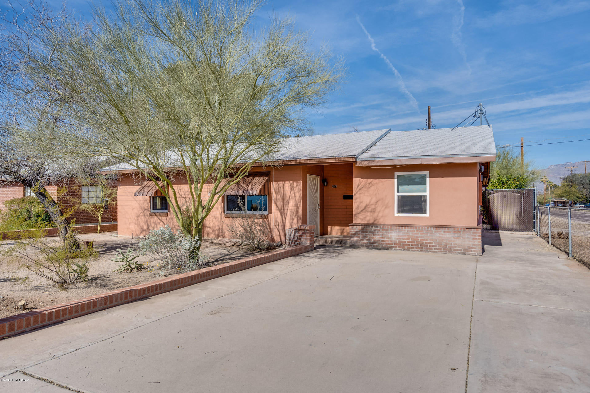 Great central location single family home. Close to Grant Modern area, U of A, restaurants, Culinary Dropout and new future Snooze restaurant. Huge covered patio, Tile floors, Granite Counters. Save money monthly on electric, water and sewer bills with Green Features that include Energy saving Dual Pane Windows, owner owned solar hot water plus Dual Rainwater Harvesting. Freshly painted interior. Backyard set up for vegetable garden. Storage area also can be used as a chicken coop. Backyard view of Catalina Mountains.  Refrigerator conveys. Parking in front and back for at least two cars
