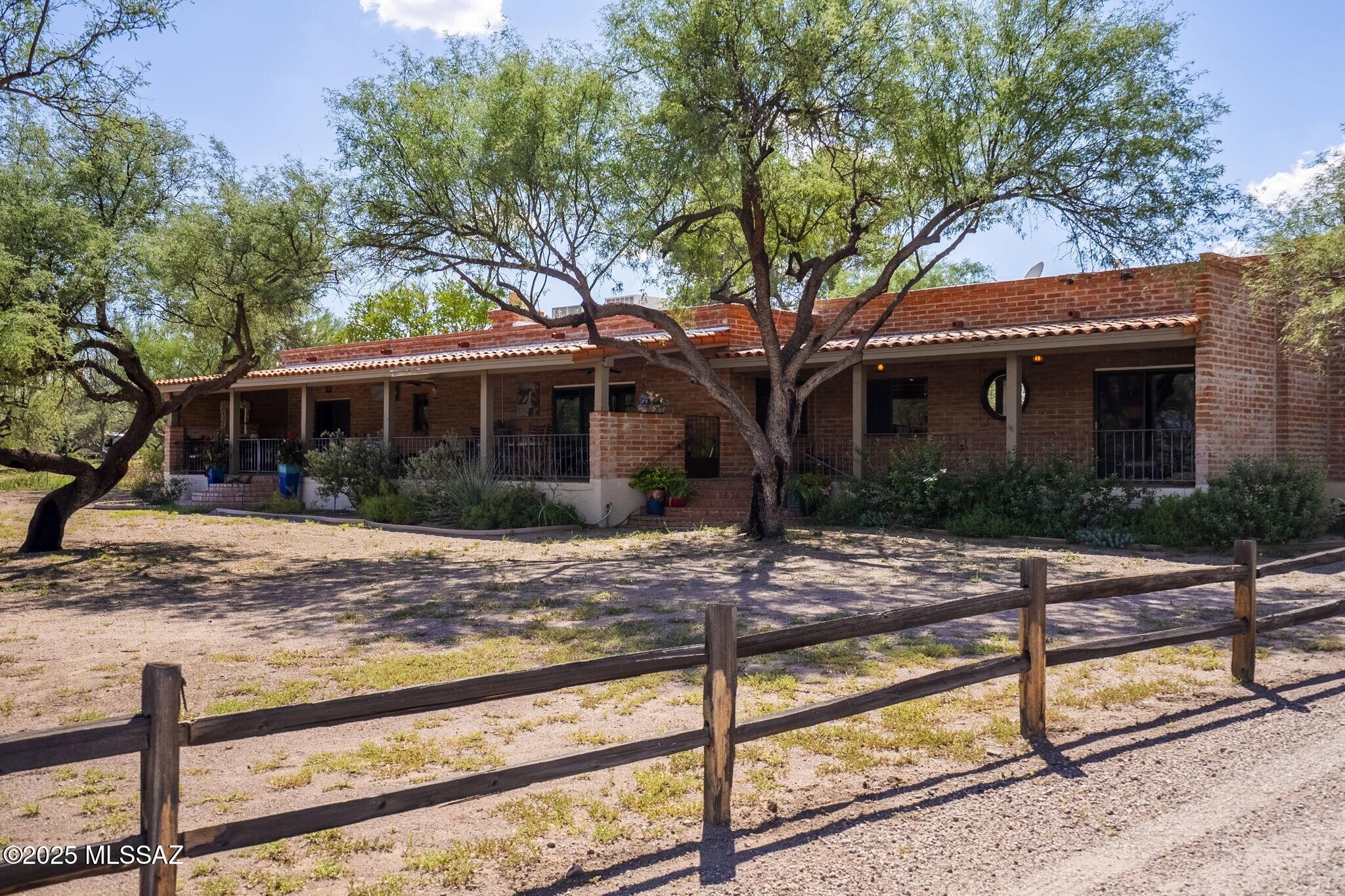 Perched on 2.14 idyllic acres, this spectacular equestrian retreat with casita offers sweeping Santa Rita and Tumacacori mountain vistas and the freedom you're looking for. With no HOA constraints, it's a rare opportunity to own your own slice of open land, horse facilities, private pool, panoramic views, plus built-in investment potential. Round pen, stalls and tack room are waiting for your horses. Multiple gathering areas provide plenty of room for daily living or entertaining. Thoughtful layout connects elegant interior living spaces to the outdoors, where you'll find a sparkling pool surrounded by native desert plantings that create an oasis of relaxation. Charming casita is currently listed on Airbnb but can also be used as a guest house or multi-gen living space.
