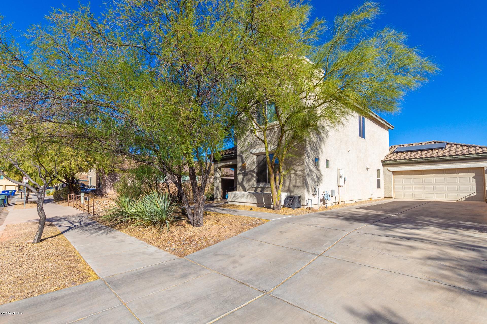 Fantastic Energy Efficient Solar two story home w/4 bedrooms, 3 baths, & 2 car garage. Spacious great room floor plan, soothing palette, plush carpet, ceiling fans, window blinds, & patio access from dining area. Center kitchen island, corian counters, breakfast bar, under-mount sink, SS appliances, neutral tile floor, pantry, & handsome wood cabinets. Guest bedroom & bath on first level. Generous size bedrooms, ample closets, & interior laundry room w/storage cabinets.  Master retreat boasts a private en suite & walk-in closet. Private backyard setting on a view lot of common area, covered patio w/sun screen, & decorative stone. Will not disappoint!