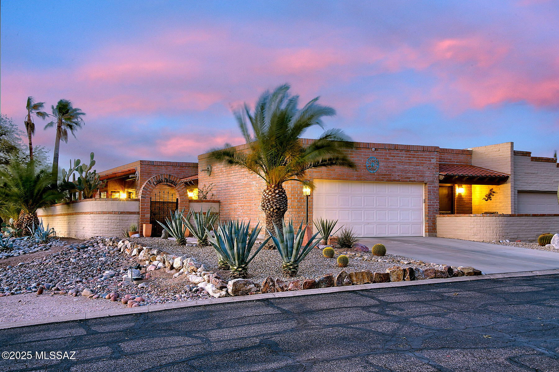 Nestled in the highly sought-after Fairfield community, this beautifully updated 2-bedroom plus den, 2-bath townhome offers over 2,000 sq ft of luxurious living space with breathtaking Catalina Mountain views and sparkling city lights. Step inside to find an exquisite kitchen featuring a Viking gas oven & hood, a Fisher & Paykel 2-drawer dishwasher, custom cabinetry with pull-out drawers, and soft-close hardware. Stunning granite countertops and a large picture window create an inviting space for both cooking and entertaining. The kitchen opens seamlessly into the spacious dining area, while the newly designed fireplace adds charm and warmth to the generous living room. The main areas are adorned with beautiful travertine flooring and large skylights that flood the space with natural light. A private  den/office with built-ins and double doors offers an ideal space for for remote work or relaxation. Throughout the home, you'll find solid wood doors that add a touch of elegance to every room. Both bathrooms have been fully remodeled with high-end fixtures, gorgeous tile surrounds, and granite countertops. The primary suite is a true retreat, featuring a jetted tub, separate shower, abundant storage, and a custom walk-in closet you'll absolutely love. The guest bedroom includes a private patio and a custom closet, adding extra appeal and functionality. The home also boats additional storage in the garage, including built-in cabinets and a utility sink, along with coated floors for easy maintenance. Convenient features like a central vacuum system, a tankless water heater, and a new water softener provide added comfort and efficiency. Enjoy the stunning outdoor space with a wraparound patio, artificial turf, and panoramic mountain views. The front courtyard provides additional outdoor space for relaxation, while the community amenities include  tennis courts, pool, and spa.This townhome offers the perfect blend of modern luxury, convenience, and privacydon't miss out on this incredible opportunity to own in one of Fairfield's most desirable neighborhoods!