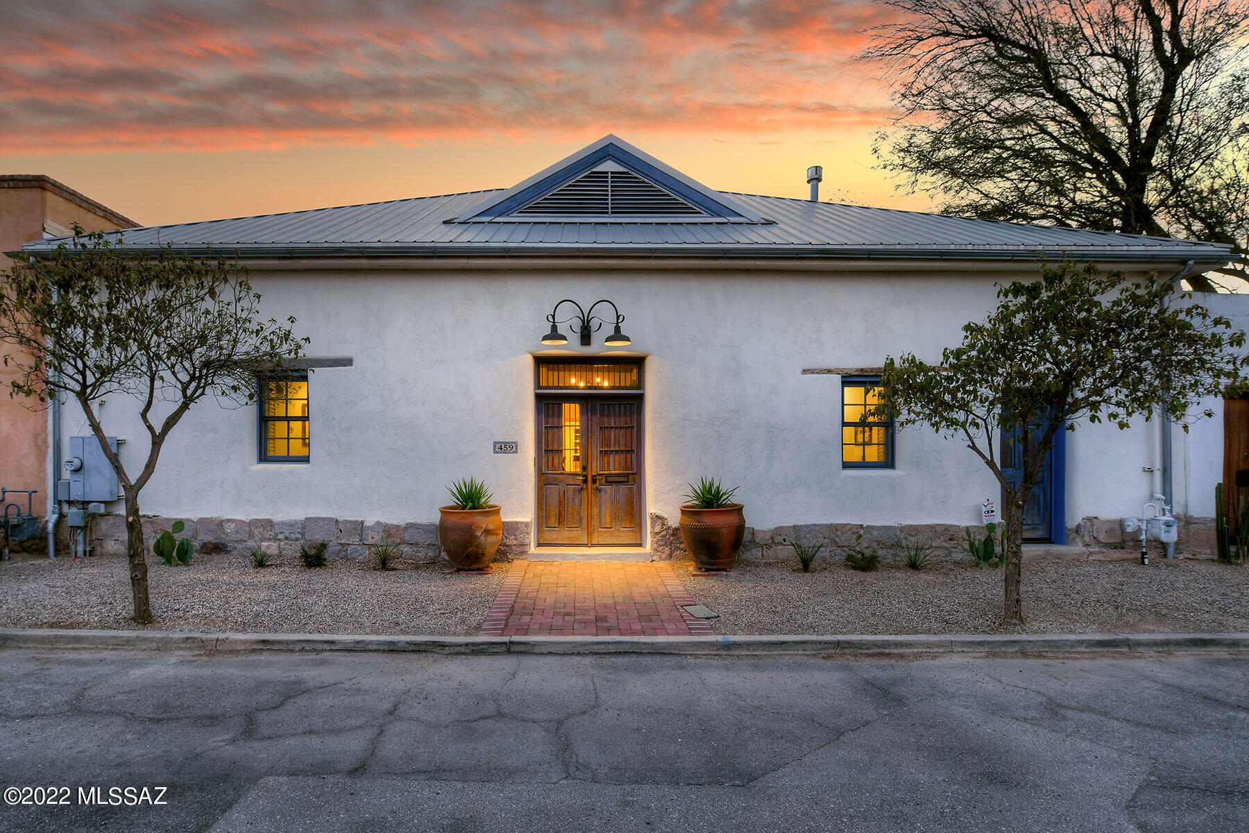 Barrio Viejo 1898 Historic Mud Adobe home. This perfectly restored, quintessential mud adobe home retains its old world charm while adding modern amenities. Beautifully appointed cook's kitchen w/slate counters, ample storage & SS appliances, charming eat-in area w/ gas FP. Large Master suite w/ walk in closets, Cupola w/clerestory windows, ensuite bathroom w/ radiant heated floors & heated towel rack, soaking tub & walk-in shower. 2nd & 3rd bedroom used as an office & 2nd bedroom has off street entrance & built in storage. Brick floors, Saguaro ribbed ceilings, Wood beams,3 FP's. Living room has central FP. Dining room used as gym.  Separate office. Green features: thick adobe walls,2-800 Gallon Water harvesting tanks, on demand H2O heater, whole house reverse osmosis water treatment. The walled back yard is an extremely quiet & private oasis & enjoys a large covered brick patio, fountain, fig, Mexican lime,& pomegranate trees +2 car carport & separate storage room/workshop that can be easily converted if desired. Historic tax reduction for owner occupied. 2021 property taxes are $2,706.12