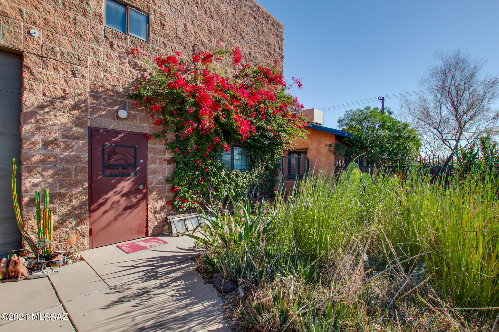 Looking for a real urban bungalow experience with ADU potential? This is it! Offering a spacious industrial loft (2506 N Stone) with a footprint of 2400 sqft, with bedroom suites, and 17 ft ceilings. The bright atmosphere is beaming with 11 skylights adding to the flexibility of a living / workspace are 2 other buildings; 2502 N Stone, unique living/workspace that is like no other. 1 bdrm 1 bath house with kitchen, and 2500 N Stone an adobe commercial space which has a loading dock, 1/2 bath, and is 1560 sqft. All zoned C-2. Would be a great location for the Gem & Mineral business, a grad student for student housing and a very unique living/workspace that is like no other.