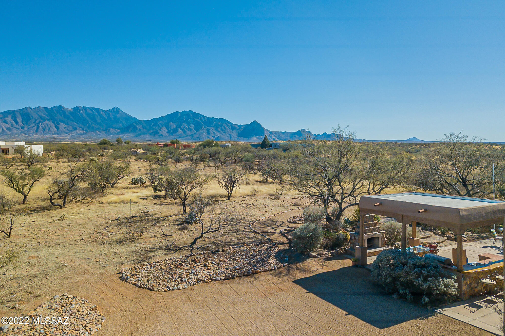 WANT THE FEELING OF PRIVACY & SERENITY but only 10 minutes from shopping? This beauty is located on 4.40 acres with the most lovely back mountain views and full outdoor kitchen. The home has 3 bedrooms, 2 baths, and open great room with fireplace. The kitchen has been remodeled with cherry and glass front cabinets, island, breakfast bar, and high-end appliances.
The outdoor kitchen has a mesquite bar, grill, fireplace, and refrigerator. Other features include tile floors, lots of ceiling fans, water softener, and HVAC only 3 years old! No HOA - GVR available. Come find your HAVEN!