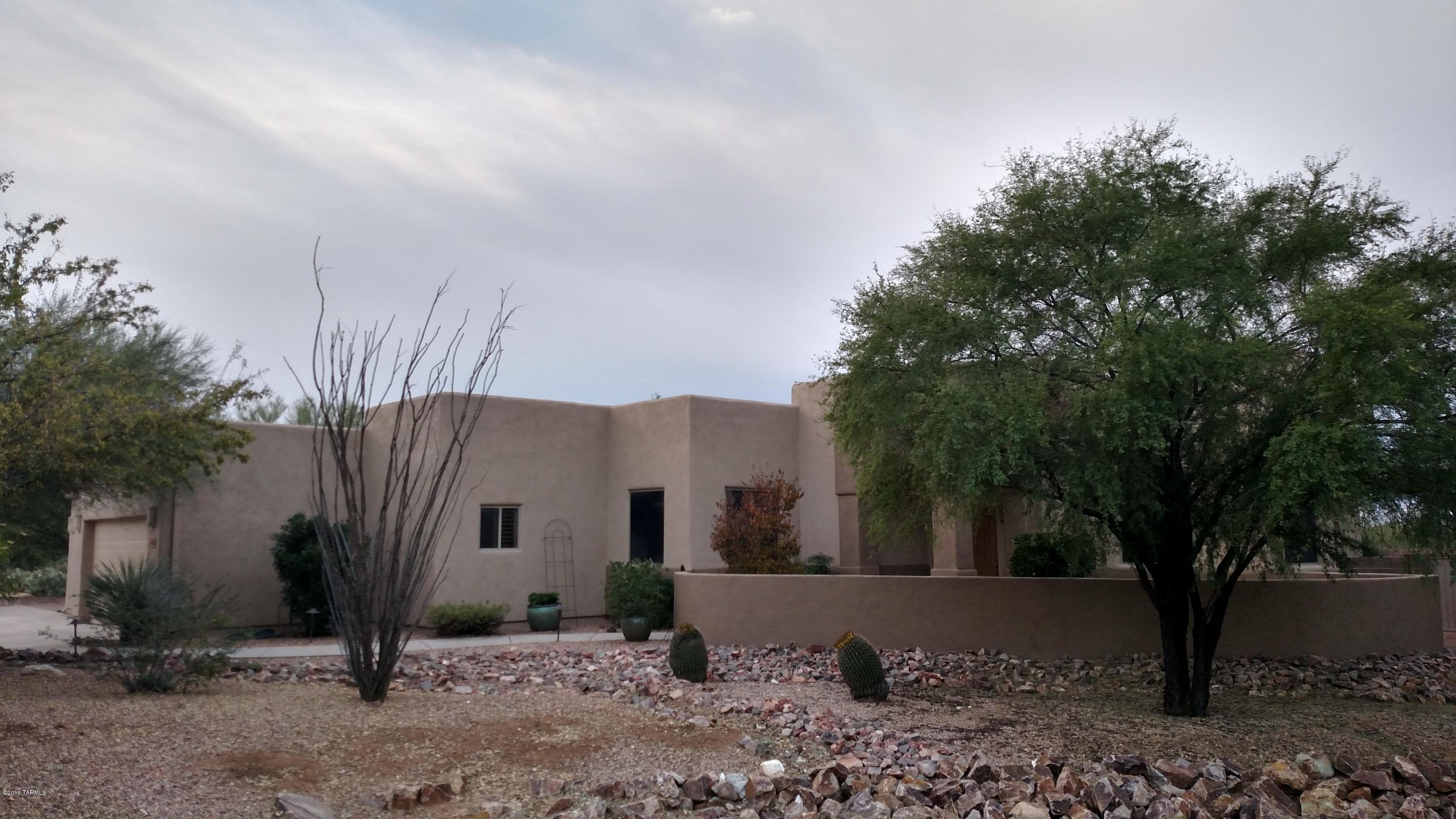 Beautiful custom home with fantastic mountain and desert views from a gorgeous back yard, perfct for entertaining. This home features 3 bedrooms plus den, 12' ceilings throughout, plantation shutters, maple cabinets, granite counters and upgraded appliances adorn the kitchen that opens to your new great room complete with fireplace and entertainment system. Master suite features his/hers closets, walk-in shower and a Jacuzzi tub. Hardwood doors throughout. Oversized three car garage with built in cabinets and a large work area. Backyard has two covered patios that wrap around home. Enjoy tranquil sunset views from the fire pit while surrounded by water features both front and back. Come see today!