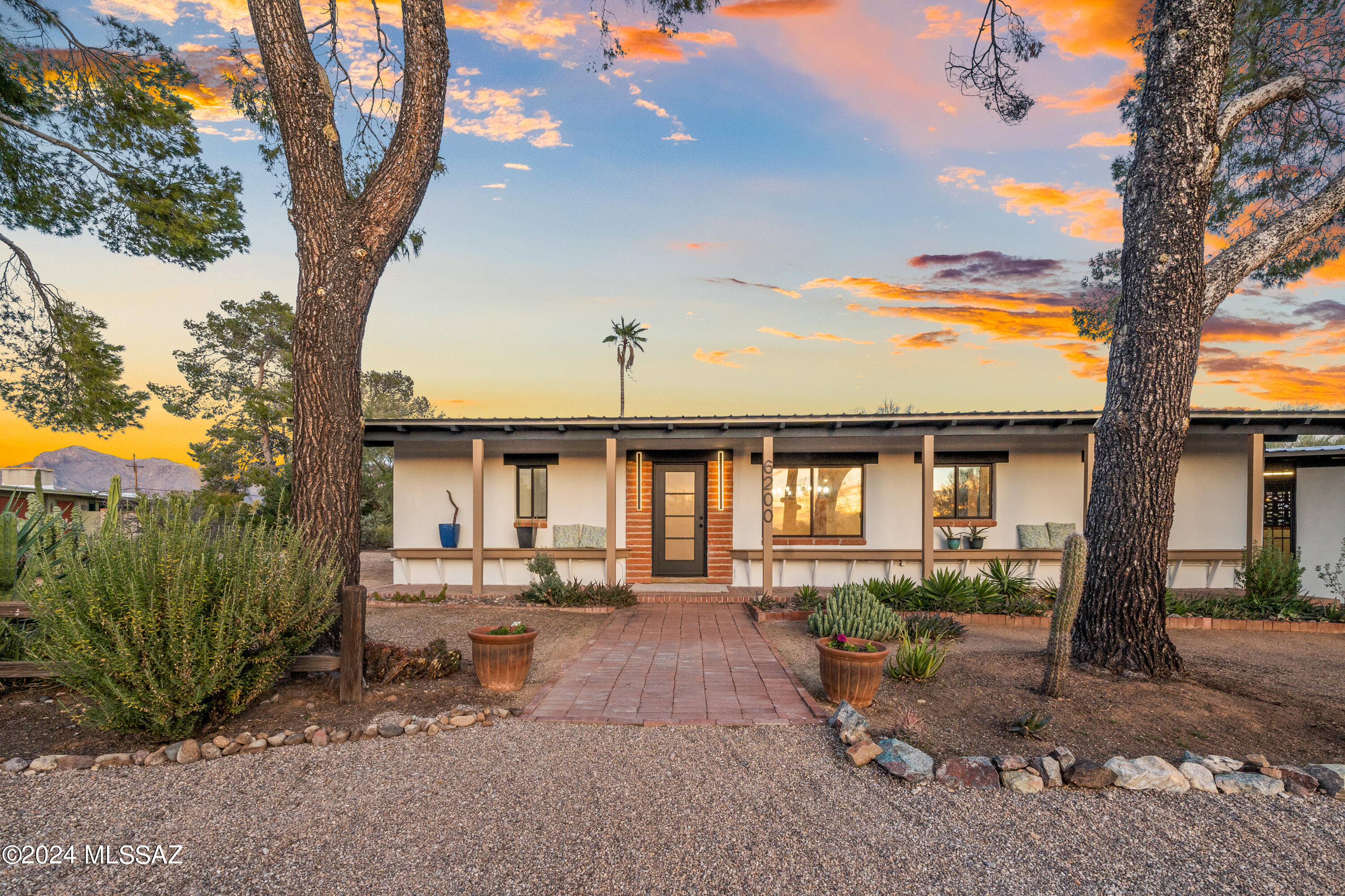 Beautiful remodeled ranch hacienda 2816 SF w/modern finishes. Gorgeous all-new gourmet kitchen & updated baths. Three bedrooms all w/private baths and one additional 1/2 bath. 864 SF separate guest house w kitchen and private bed/bath  could be rental, office, or mother-in-law. Main kitchen opens to the family room w wood burning fireplace. Big dining room & separate bonus space for game/playroom or den. New exterior doors, lights, & plumbing fixtures. Metal roof.  No HOA!  Total 4 bedrooms and five baths. Two courtyards off main home. The neighborhood has a suburban feel, but it's just one mile from Oracle Road and NW Medical. Least expensive 3500+ SF single level home on 64,000+SF lot in all North Tucson. Next similar active comp $1.695MM!
Owner is a licensed AZ real estate agent.
