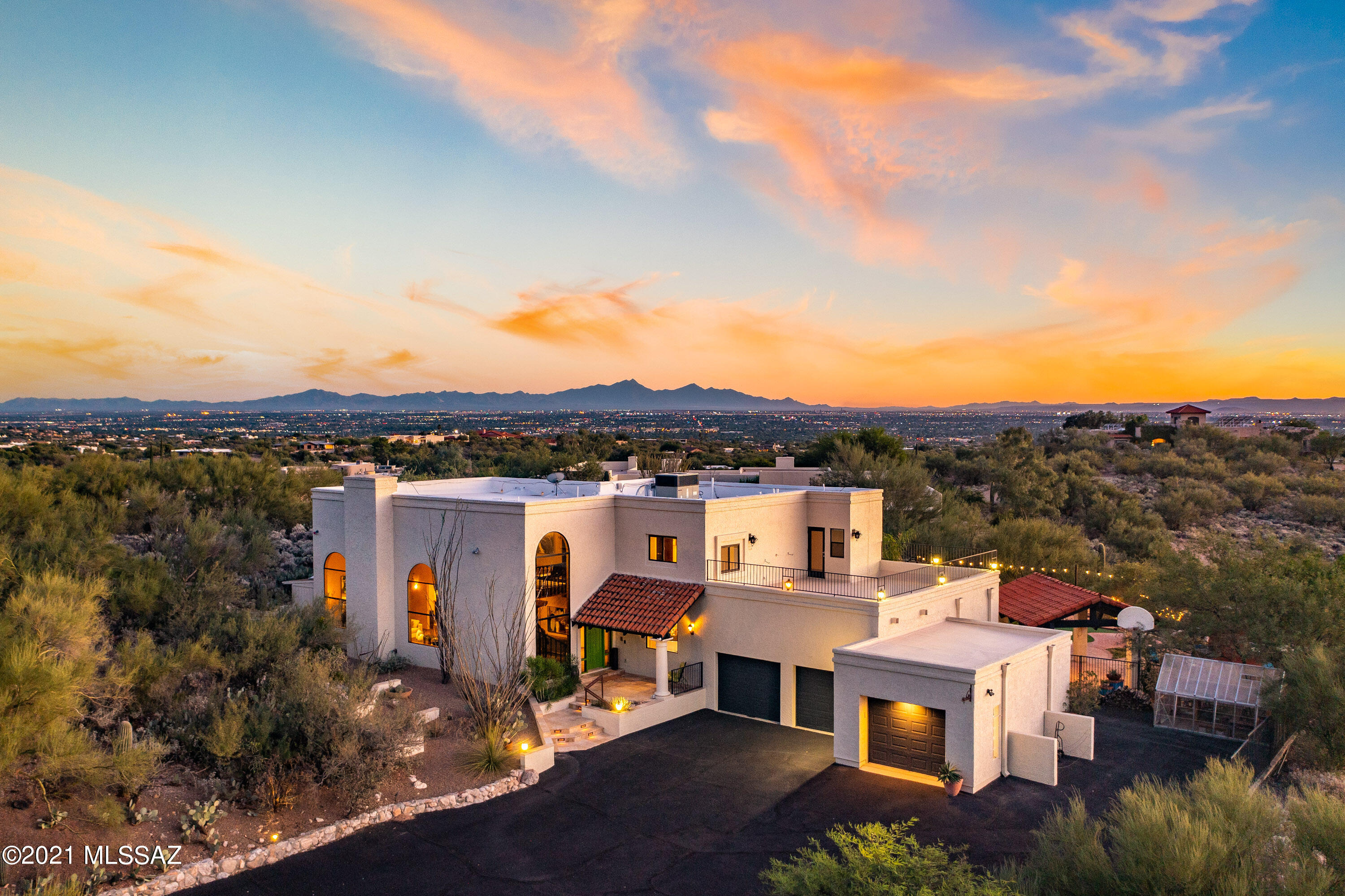Location, Location, Location! Situated on a dramatic view lot in the heart of the Foothills, is this tastefully updated 4 bedroom contemporary home designed for entertaining with a great floorplan & resort like backyard to experience & enjoy the sought after Tucson Lifestyle. As you enter, your eyes are drawn to the spacious living room featuring a gas fireplace, soaring ceilings, large picture windows framing the Catalina's and ample wall space for a large art collection. The gourmet kitchen features granite countertops, stainless appliances and opens into the family room, a breakfast nook and leads to the formal dining room w/a built in buffet & wine fridge. Downstairs also offers a guest suite w/bath, Rogo's concrete floors, LED lighting, a powder rm, large laundry rm w/utility sink & an oversized 3 car garage w/workshop & storage. Upstairs you will find the luxurious master suite w/hardwood floors, spa like bathroom w/walk in shower, soaking tub overlooking the city lights, custom closets and a view balcony overlooking the sparkling pool & spa and the most spectacular sunsets in the world! In addition, you will also find two large bedrooms upstairs along with a full bath and roof deck. The backyard is an entertainer's dream featuring an outdoor kitchen w/pizza oven, bbq grill, sink & fridge, Ramada w/flatscreen tv, fireplace, Bocce Ball court, artificial turf lawn, and a newer built in Jacuzzi overlooking the twinkling city lights. Enjoy the incredible privacy, quiet, and NO HOA!