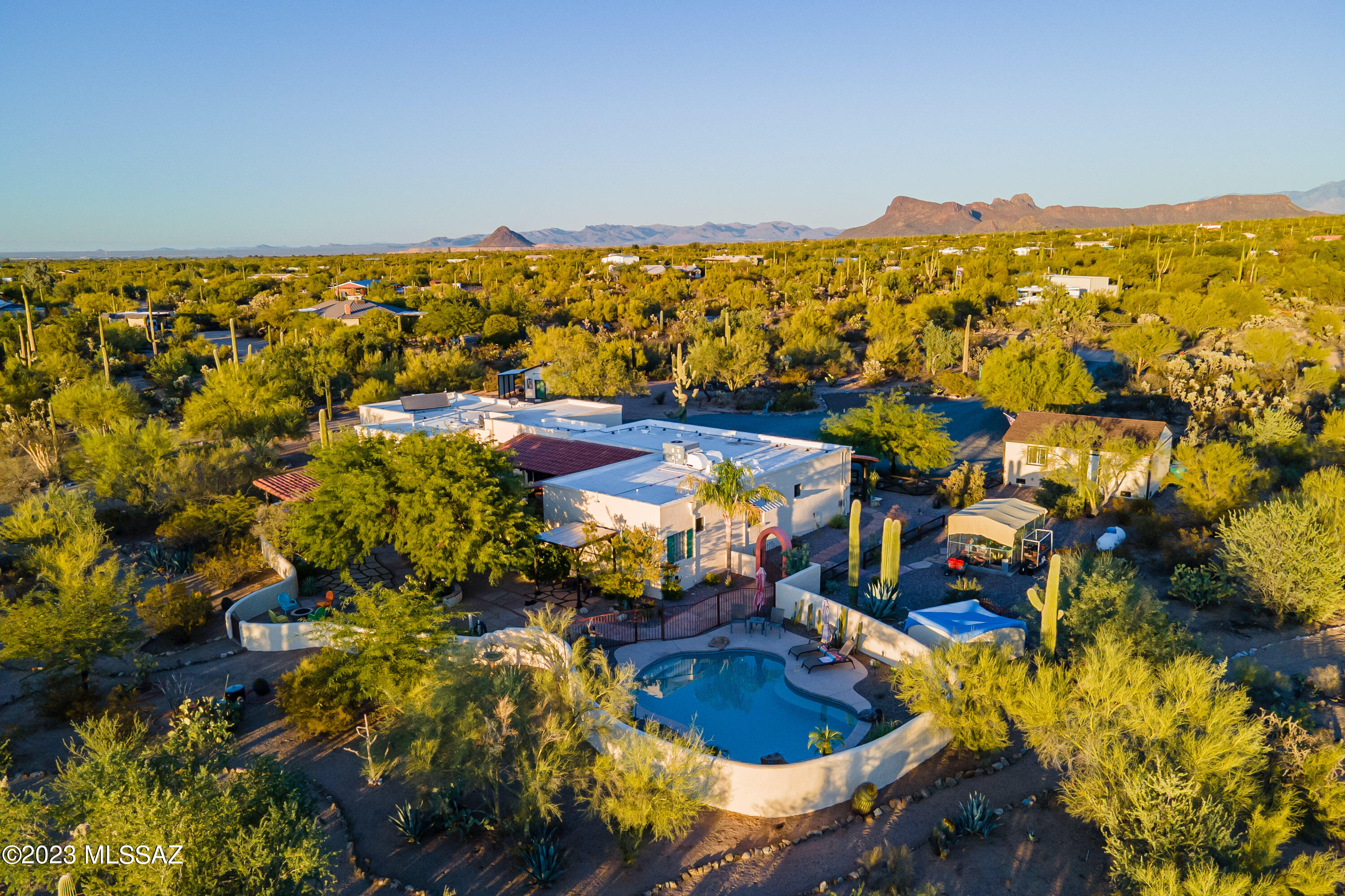 Breathtaking Hacienda on over 4 acres of highly vegetated desert w/ mtn views. This is your chance to own your very own ranch/horse property. Drive up to this impeccably maintained superior ICF construction home through an iron monument. This home offers 4bd or 3 + office & 3 full baths PLUS a powder room. One bdrm w/en-suite bath. Hand crafted many upgrades include a new custom swimming pool w/heater, 3 new AC units, roof re-coated in Dec., new AV equipment, Pella windows, 2 copper sinks in kitchen, pasta faucet, gas cook-top, SS appliances, interior solid wood doors, stained concrete floors, hand painted tile in kitchen & bathrooms, gorgeous professional landscape design, outdoor kitchen/BBQ, outdoor lighting, several covered porches, new exterior paint & trim, RV hook-up w/parking pad