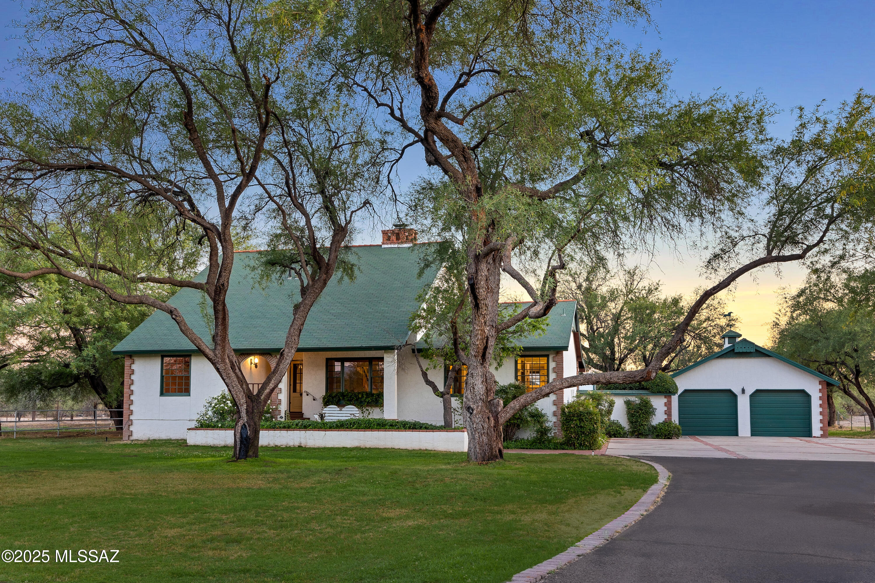 Tucked in prestigious Tanque Verde Country Estates, this charming farmhouse sits on a rare 4-acre parcel with a private well and grandfathered irrigation rights ideal for lush pastures, trees, and gardens. Horse-ready with two stables and direct access to scenic trails via the Tanque Verde Wash. A classic hay barn has been converted into a five-car garage with flexible use. The warm, two-story home features 5 beds, 3 baths, a country kitchen, dining area, and a double-sided fireplace. A lofted library adds a peaceful retreat.The backyard features a pool, a relaxing spa, and a charming gazebo for outdoor enjoyment. With equestrian amenities, secure water, and adaptable space, this is a unique opportunity to own a functional estate in a coveted location.