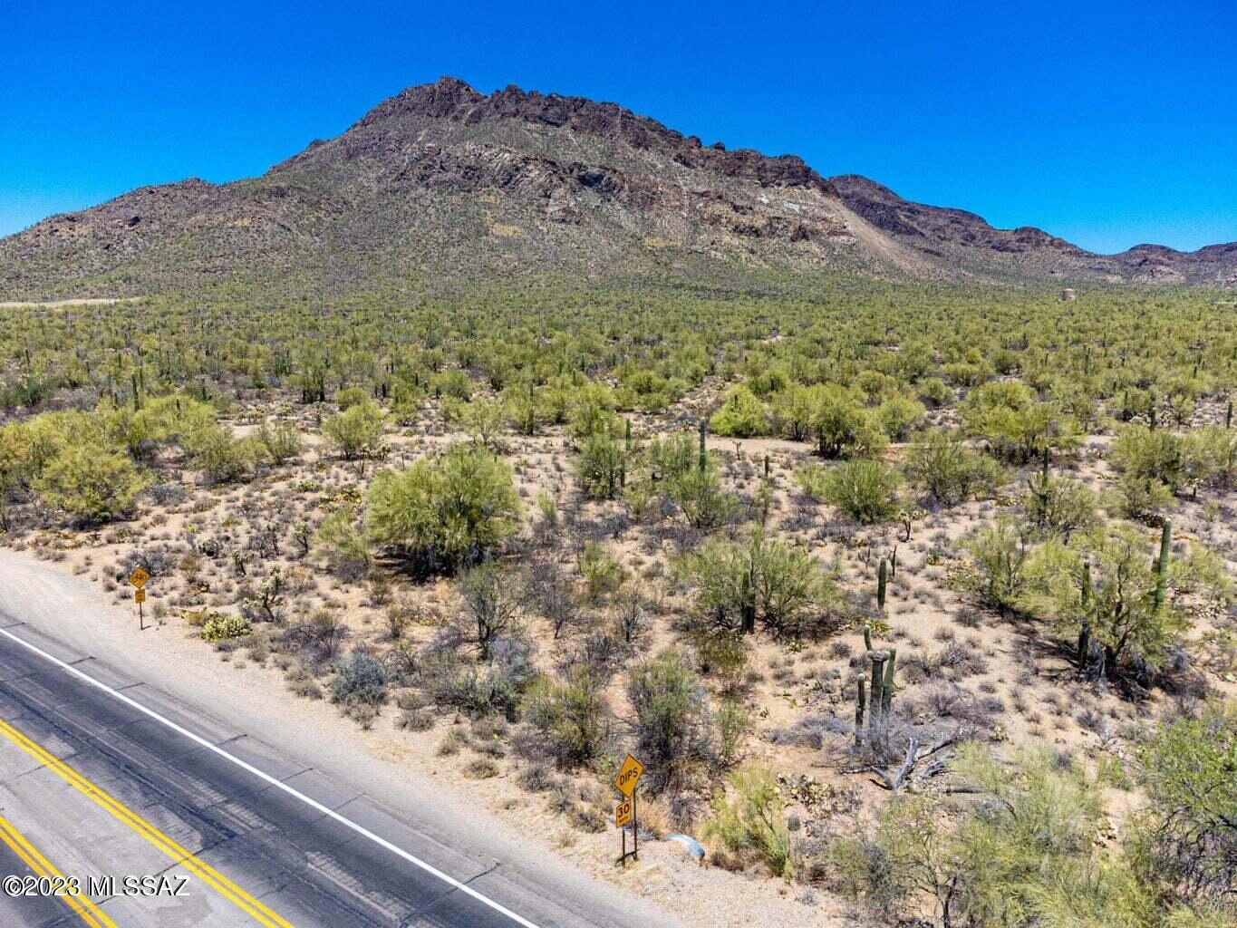 SELLERS ARE ACCEPTING BACK-UP OFFERS THROUGH AUGUST. CB-1 zoning allows for both business and high-density residential uses allowed under TR zoning.  CR3, CR4 & CR5 uses are allowed. This three-sided parcel abuts TUCSON MOUNTAIN PARK. The smaller, narrow parcel abutting this parcel is included. Tax I.D. for smaller additional parcel is 212-29-0010 (.25 acres). These are the last 2 parcels on KINNEY RD. before you enter the Tucson Mountain Park: home to OLD TUCSON, SONORAN DESERT MUSEUM & GATES PASS. The close-up mountain views behind this land are awe-inspiring. This is a very serene location. Ideal for MULTI-FAMILY housing, single-family home(s) or retail business.