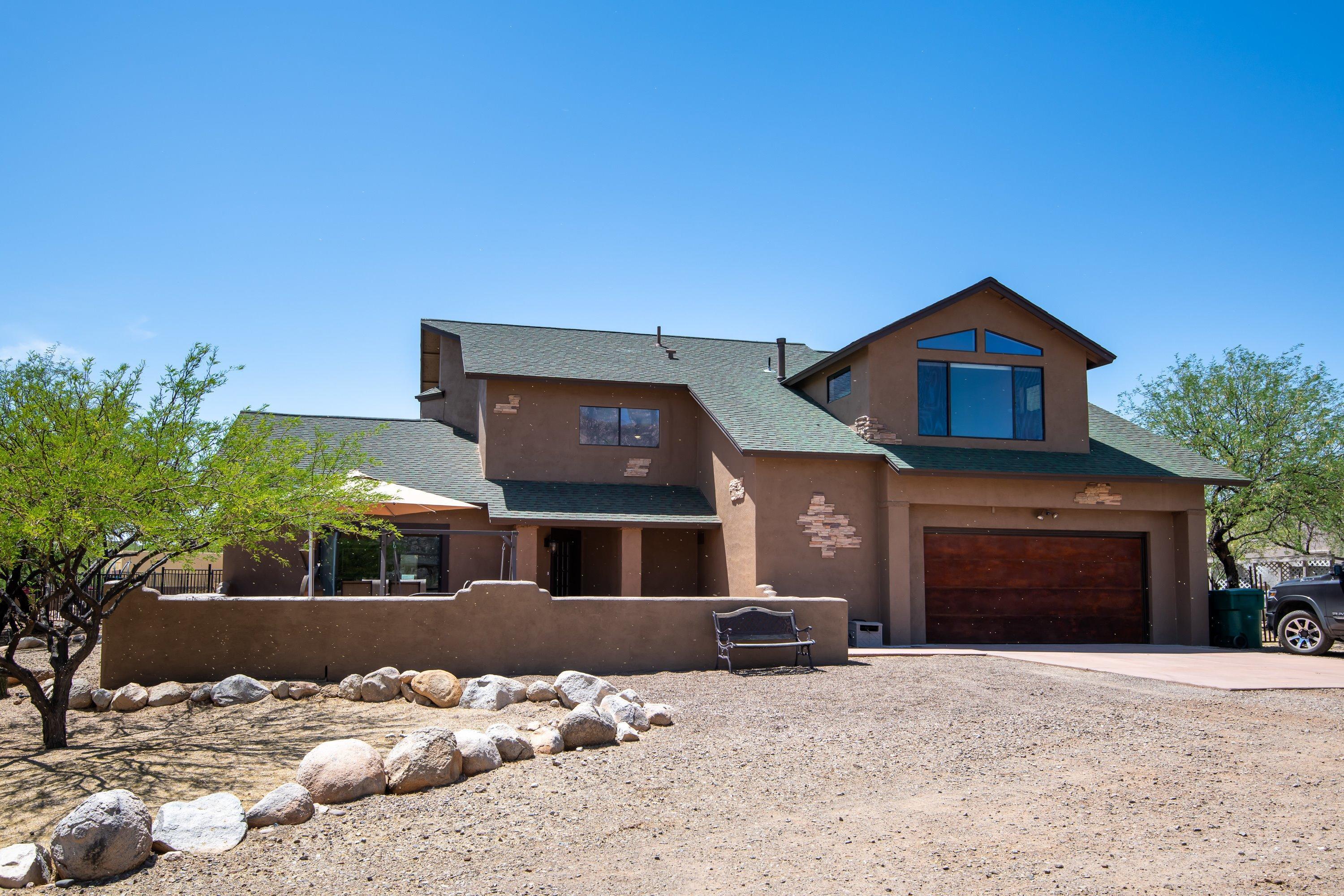 This one of a kind, recently remodeled home sits on the edge of State and National Forest land with breathtaking views of the Catalina Mountains. This is a large, 2-story home which takes advantage of the marvelous views with easy access to get out and enjoy the area. Upstairs features Loft Library for lounging, a huge Master Suite with new large walk-in closet, Master Bath with walk-in shower, and a very large picture window for spectacular panoramic views. Down the hall are two large Bedrooms connected by a Jack-&-Jill bathroom, and an upstairs Laundry! A fourth Bedroom/Office with glass french doors is at the top of the stairs near the third upstairs full Bathroom. Main level contains a large Living Room with Sliding Doors to view the mountains, newly remodeled/upgraded Kitchen. Kitchen connects to a Dining Room, Powder Room, and the downstairs Laundry.

Walk through the in-house connection to the Guest Quarters. This area is its own apartment with full Kitchen, Living area and Bedroom. It has a full Bath with roll-in shower, and a walk-in closet. This Area has its own entry off the back patio and is totally tiled. Use it as Grandma's quarters, a changing area for the pool, or your personal space. There are so many options!

Your friends & family will enjoy the sparkling Salt-Water Pool, oversized covered Patio, Fire Pit, and an acre of beautiful natural landscape. There is a large Workshop with AC, and a covered 30' RV area. If you love to just watch the mountains and wildlife, the Ramada is the perfect place to pause.  And, if that isn't enough, there is plenty of room for your corral  so bring your horses if that's your thing, and ride out the back gate. No HOA so it's up to you to decide.

Situated perfectly on a one acre lot in order to capture the most magnificent views of the Santa Catalina Mountains. With direct access to the 1.78 million-acre Coronado National Forest, this property truly is something you won't find just anywhere! Sitting at an elevation of 3300', the property has been mindfully landscaped using local boulders and desert-adapted plants, primarily natives, to be in harmony with the adjacent Sonoran desert. There is a back gate that opens up for easy access to the National Forest and directly connects to miles of trails for hiking, mountain biking and equestrian use. Some of the globally recognized trails include 50-Year, Deer Camp, the Chutes, Middlegate, Upper-50, Slickrock Lollipop, Baby Jesus and Dynamite Canyon.

Perfect for outdoor enthusiast to enjoy horses, hiking, and biking all on State and Federal land right outside the Backyard gate! 
Your oasis retreat is waiting!!