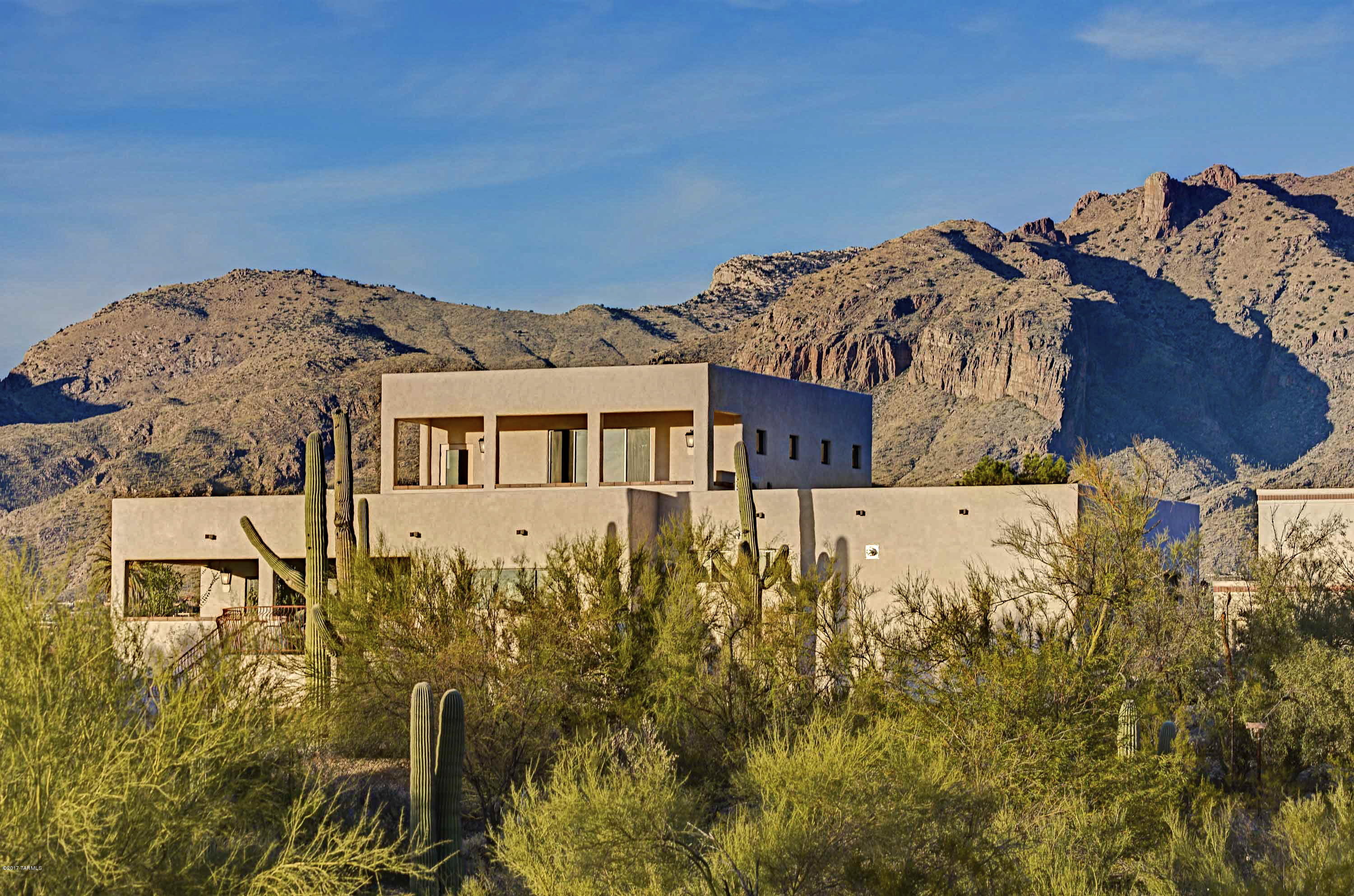 Spanish contemporary in the Old Foothills features panoramic views in a comprehensively remodeled home. Set back from the street, this home is in move-in condition. Custom designed sliders provide seamless transitions to both the north and south terraces to the gracious living/dining room. Master suite contains bath with dual vanities, large separate shower and a soaking tub. Also on the main floor, a separate wing includes two additional bedrooms. The custom kitchen includes cherry cabinetry, quartz counters, all new SS appliances, contemporary recessed lighting and a separate pantry. All mechanical systems were updated in 2016: 3 new zoned heating/cooling systems, new interior electric and plumbing with tankless hot water heaters. Upstairs features a large media/family room with bath t accommodate additional guests. Storage abounds in 3 garages and in oversized interior closets. Relax in this modern classic, with beamed ceilings, custom concrete flooring and a sparkling pool, your own retreat.