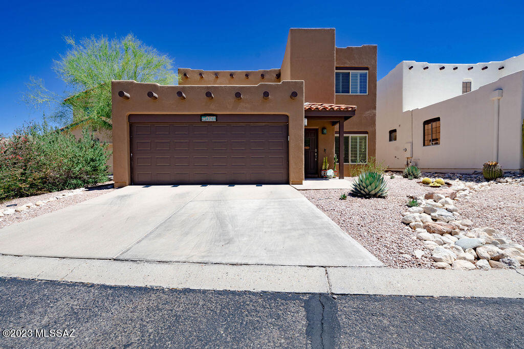 Beautiful Sante Fe style home in gated La Reserve community. Spacious 4 bedroom, 2.5 bathrooms include a Primary Suite with a walk-out covered balcony and updated bathrooms.  One of the secondary bedrooms includes a murphy bed for your guests.  Backyard oasis backs to natural desert area and Mountain Views to enjoy all year long. Community pool easily accessible for those hot summer days. Don't miss the opportunity to make this home yours!