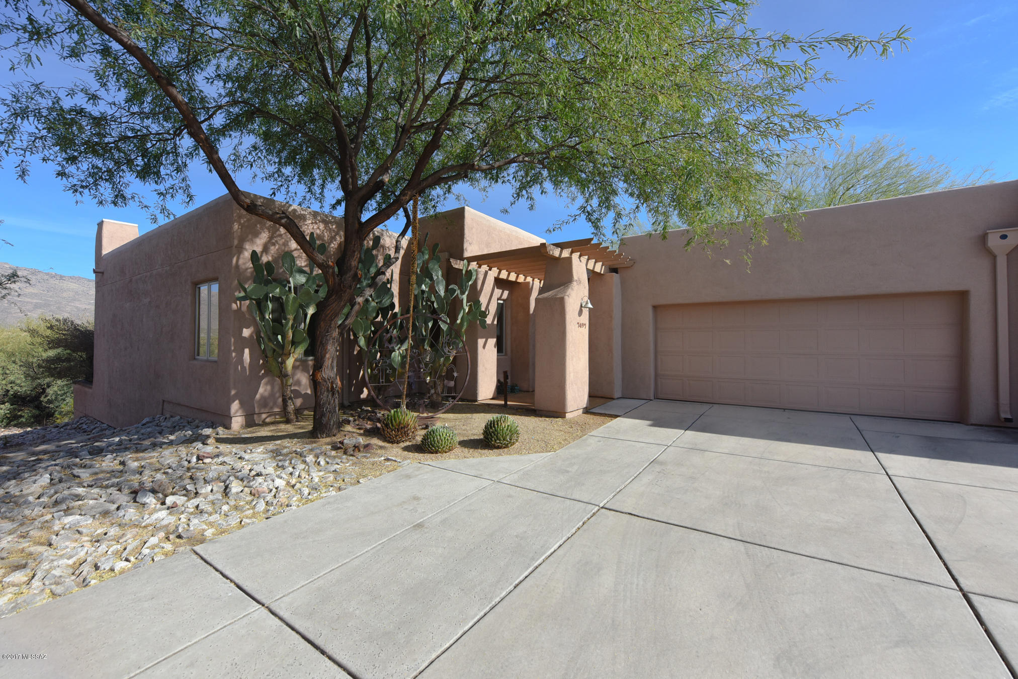 Spectacular unobstructed views with solar and a casita!  Overlooking the Rincon Valley and Saguaro National Park. The dining/living room is an entertainers dream with soaring ceilings, oversized view windows and doors that open onto the huge covered patio. The open kitchen has a Sub Zero fridge plus a lower height island and stove for handicap access. Inside features tile floors, 3 bedrooms and 2 bathrooms, and two of the bedrooms can be used as an office. Details include Pella view windows, solar panels and hot water, upgraded cabinetry, fresh paint, recoated roof, skylights, and lots of storage. Enjoy the year round heated pool, new gym, exercise programs and more. The Arizona Sr. Academy is the cultural hub of the community with events, concerts, and programs for lifetime learning.