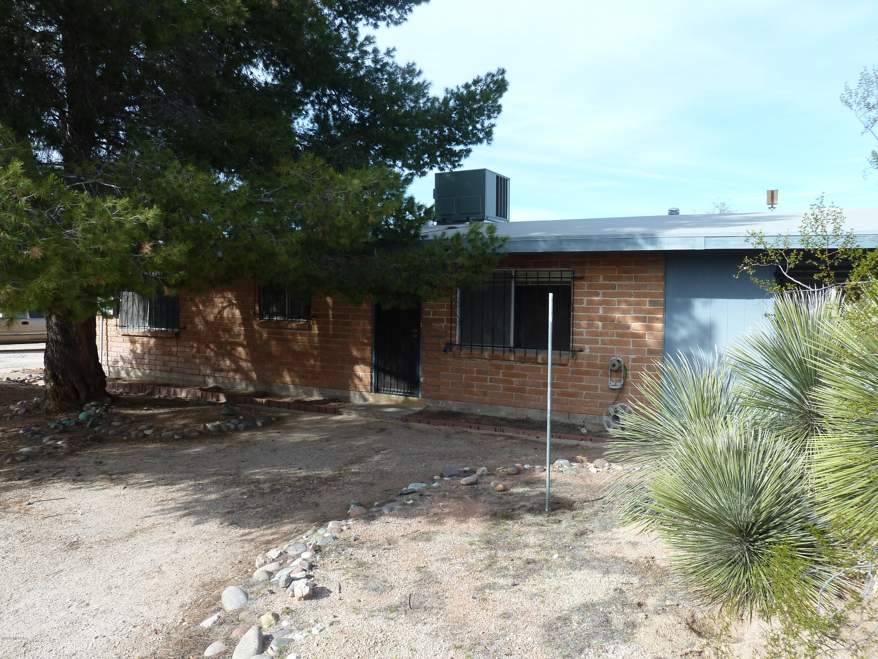 Almost 2 acres of beautiful desert privacy but in town conveniences. Many options with R-2 zoning. Cozy burnt adobe with a country feeling.