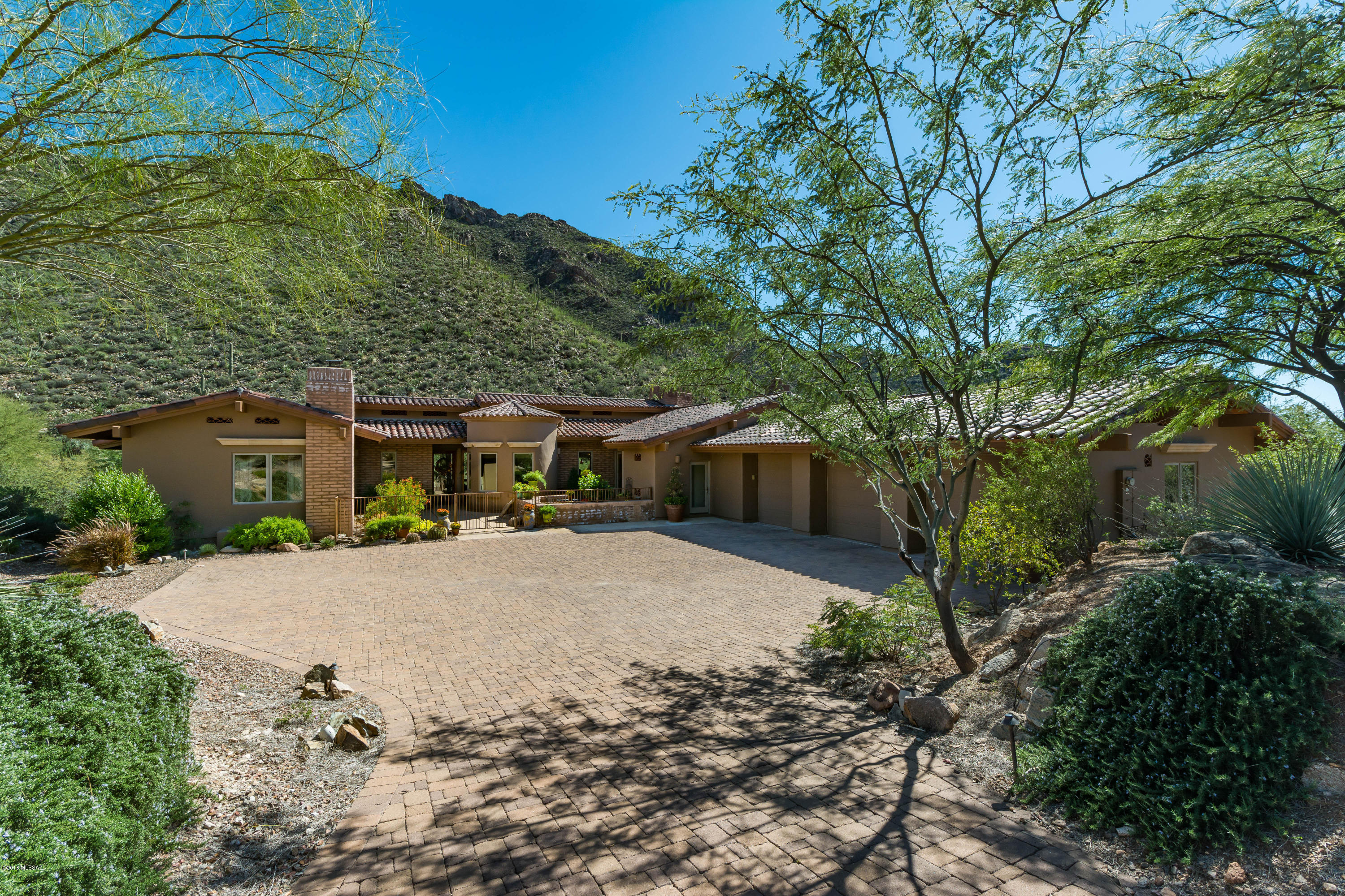 Mesmerizing saguaro studded mountain views from this elegant stunning custom home nestled on a very private  lot in gorgeous Canyon Pass at Dove Mountain. Exquisite fine features include rich wood beam ceilings, sprawling gourmet kitchen w/stainless steel appliances,  elongated island, unique granite countertops, rich/gorgeous stained concrete floors, abundant custom  workworking just to name a few. Remodeled pool & spa with expansive outdoor living areas including new fireplace w/raised planter box. Pool  upgrades include: new pool/spa heater, upgraded  AquaLink controller system, new variable speed drive motor. Remodeled master bedroom, master bath & half bath.  Expansive, oversized 3 car garage. 4 bedrooms or 3 bedrooms + office/den.  Dual master bedrooms - both w/fireplaces.