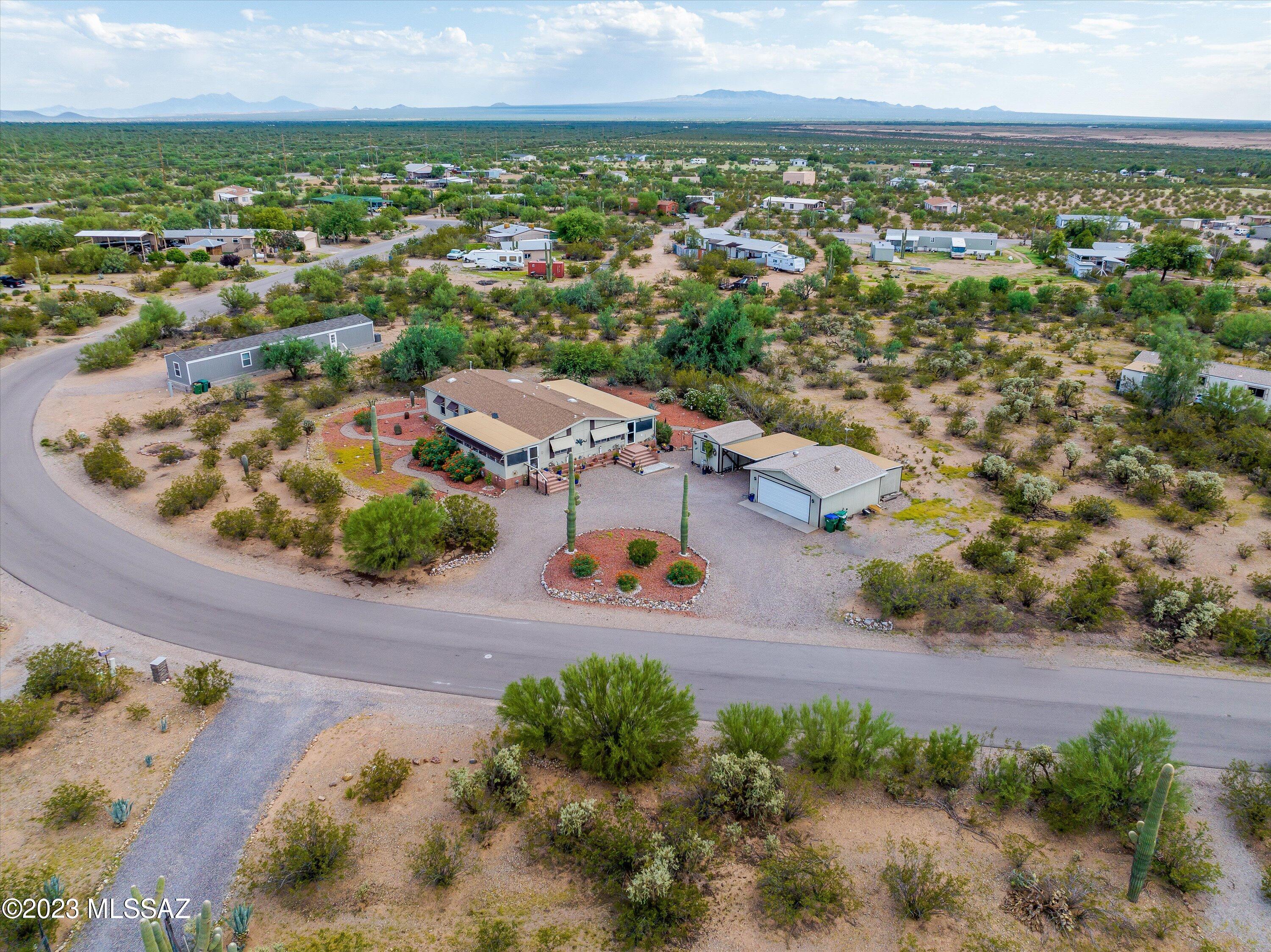 Don't miss out on the unique opportunity to own this Amazing 1,820 sq ft, 3 bed / 2  bath split bedroom floor plan with 2 separate living spaces on over 1 Acre with NO HOA and surrounded by the Majestic Beauty of the Southwest. Relax and Enjoy the serenity, privacy and natural desert beauty with Spectacular views of the Mountains, Saguaros, Sunrises, & Sunsets.  This property includes a  2 Car Garage & separate insulated 10' X 14' Storage Shed with Electric and wall mounted AC unit perfect for a workshop, mancave, arts & crafts room and more. There's 2 large enclosed, screened Arizona rooms /  patios great for Relaxing and enjoying the Beautiful views. Large master bedroom has a spacious walk-in closet, double sinks as well as a sit down vanity area and a walk-in shower.