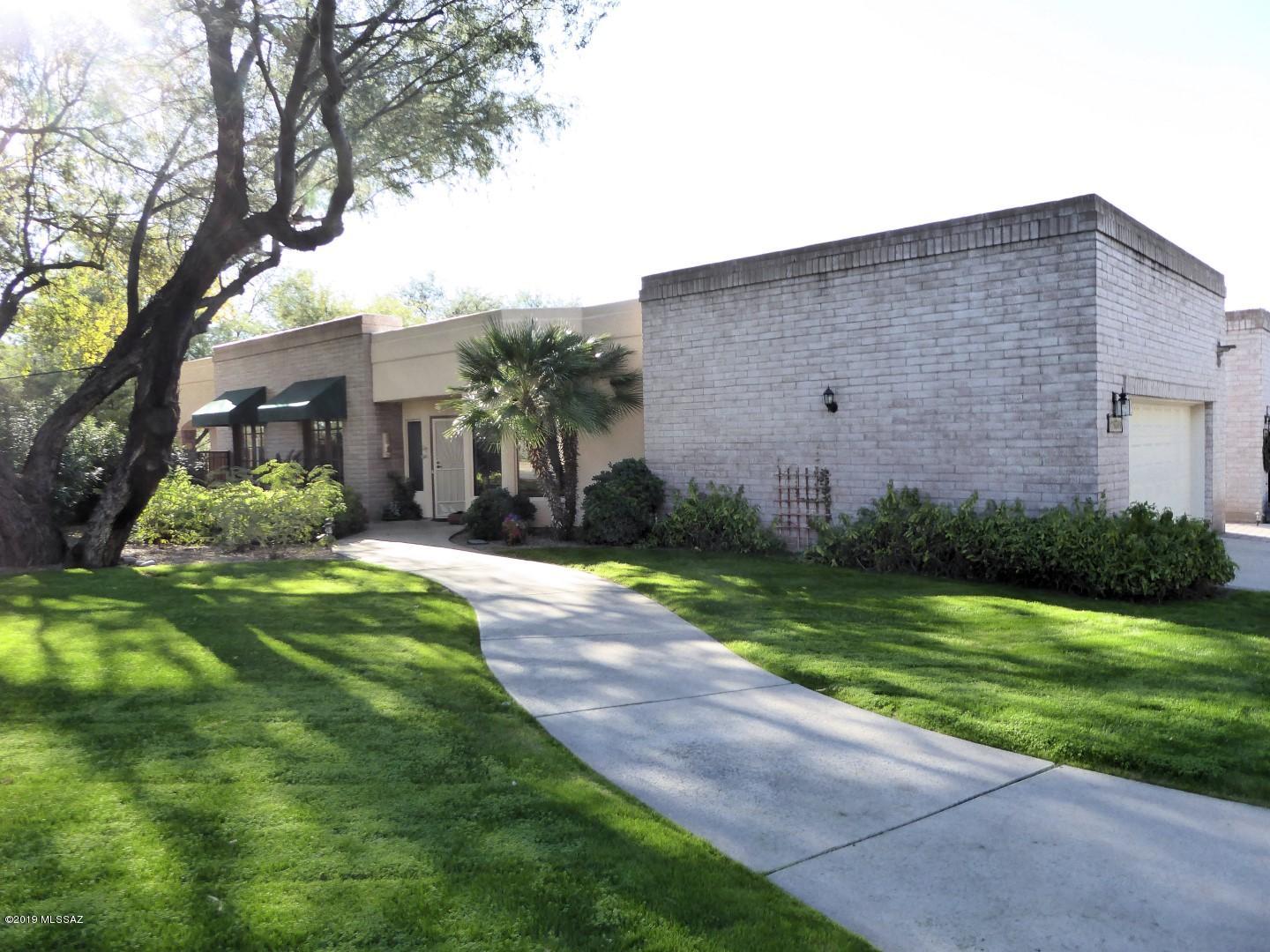 A spectacular Zero-lot-line home which was the original Model Home. Very high quality and immaculate condition. Updated kitchen with granite tops and stainless appliances. Features 2 bedrooms plus an office and a small exercise room. One of the best lots in the subdivision which adjoins community pool and large green lawn which is maintained by the association. Good size rear yard has built in grill and overlooks the Rillito River Path. This is a very special property!