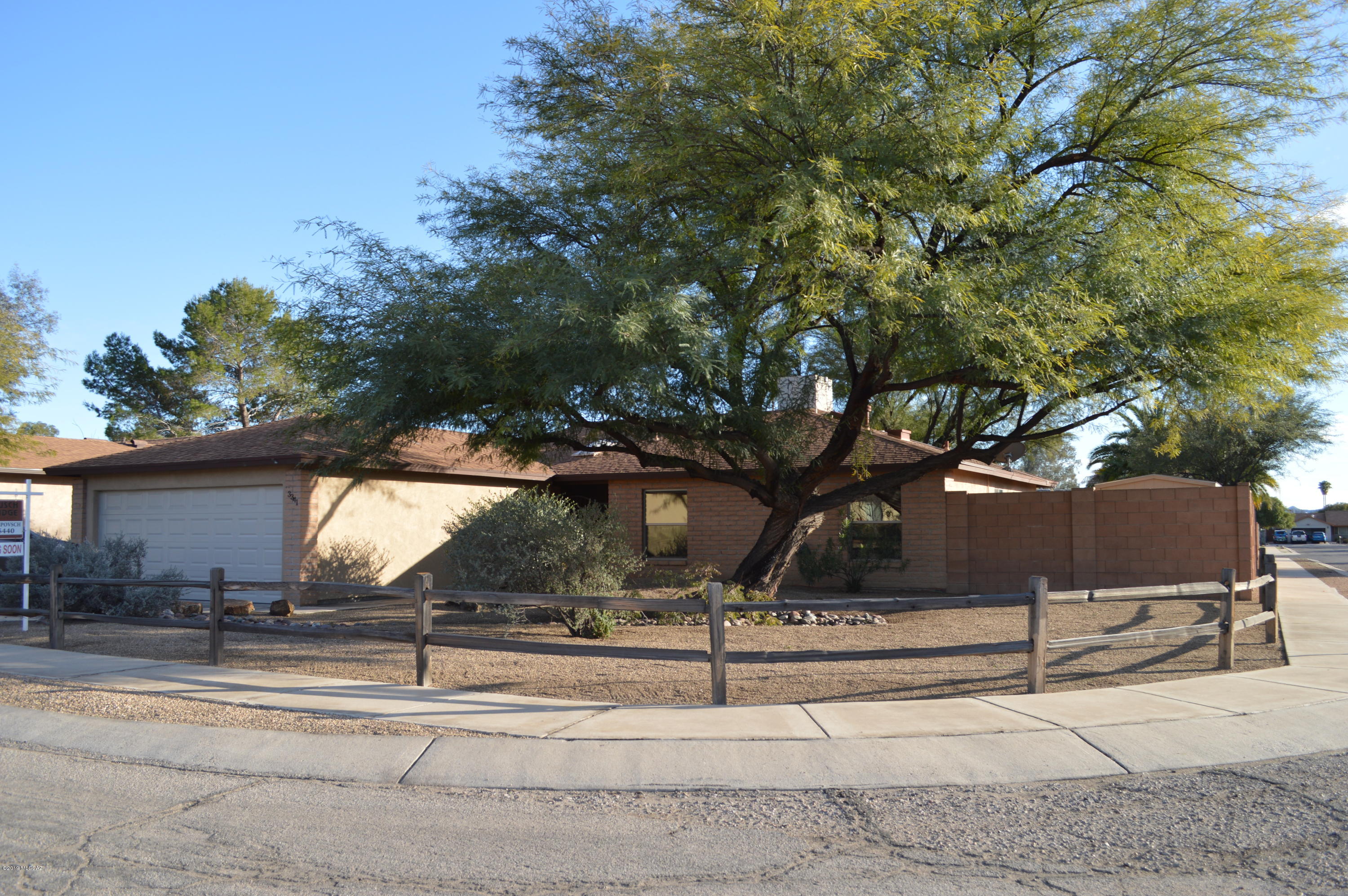 Adorable ranch home in Northwest Tucson! 3 bedroom, 2 bath with ceramic tile, updated bathrooms and large pool sized yard. Block wall, custom wrought iron gates  and beautiful mature trees complete the exterior of the home. Relax by the cozy fireplace in the open living/dining area. Kitchen includes all appliances and has two pantries for added storage. All bedrooms have wood floors for easy upkeep. Located near shopping, restaurants and neighborhood park.