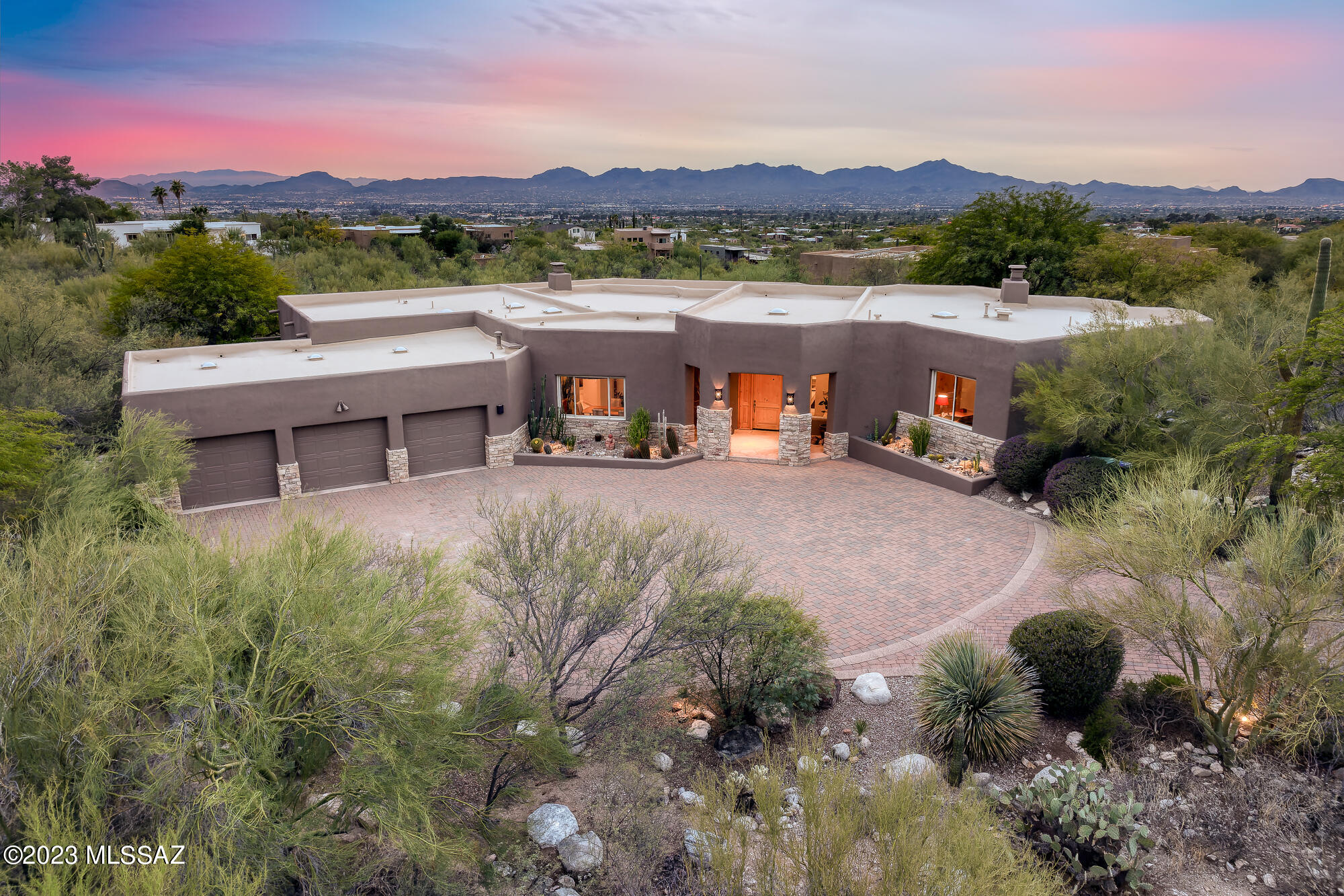 Welcome to your serene desert oasis nestled in the prestigious gated community of Pima Canyon. This luxurious 3713 sq ft, 5-bedroom, 4-bathroom residence sits on nearly 1.5 acres of meticulously landscaped desert terrain. Greeted by breathtaking vistas of the Catalina and Tucson Mountains, as well as captivating city lights, this property boasts panoramic views in this elegant setting. Designed for both privacy and functionality, the split-bedroom plan offers tranquility and space for all. The heart of the home, a spacious chef's kitchen, features top-of-the-line Viking stainless steel appliances, perfect for culinary enthusiasts and entertaining alike. Step outside to an entertainer's paradise - a negative edge pool and spa invite you to relax while soaking in the stunning surroundings.