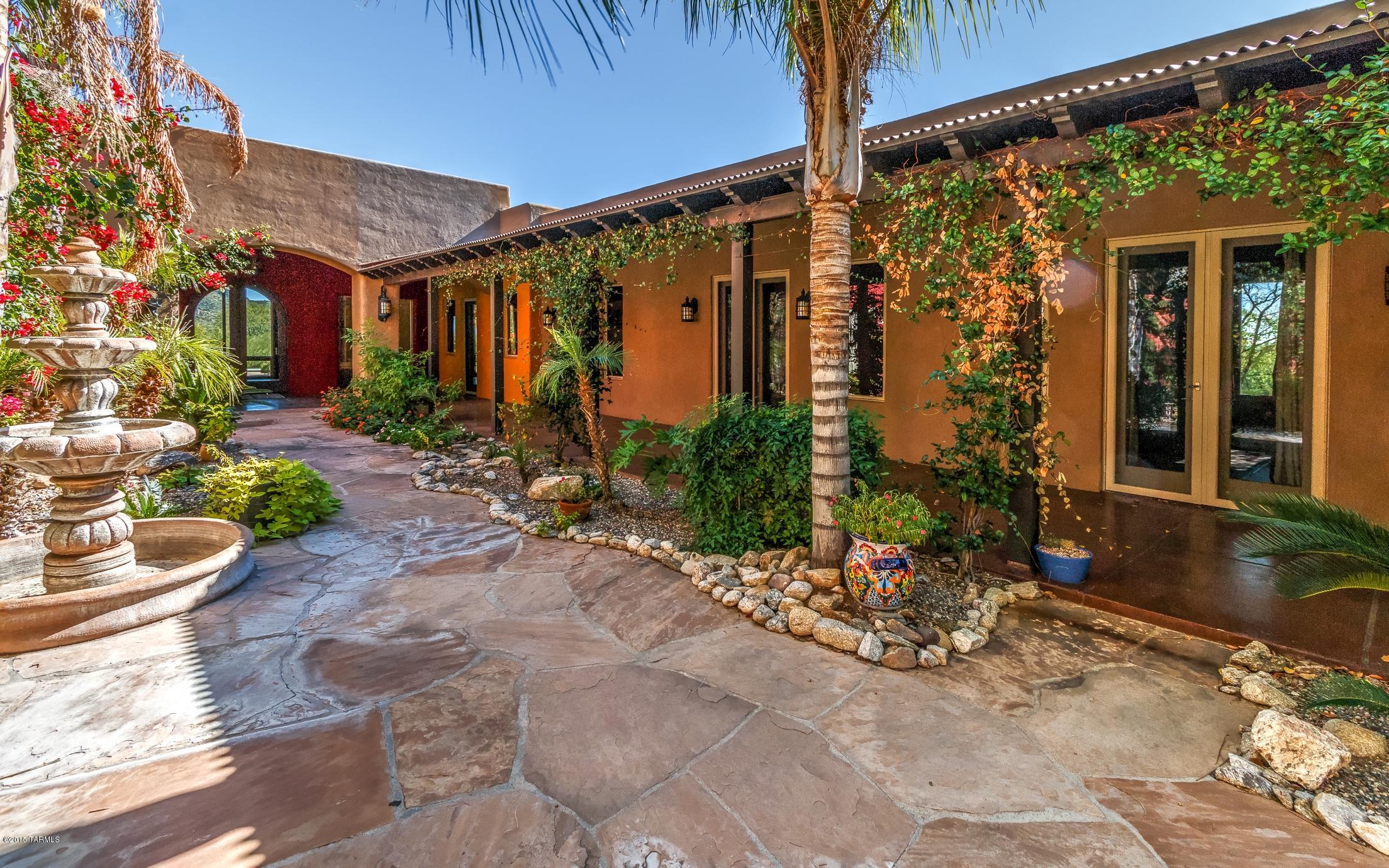 MAJOR PRICE REDUCTION! Gorgeous kitchen with granite countertops and Viking appliances. Sub-Zero fridge. Walk-in pantry. Reverse osmosis water filtration. Find your home away from home in this unique, sprawling custom home. Guest quarters or gym space just steps above the garage, with kitchenette, separate bed and bath, and private balcony and entrance.  Beautiful home just steps from Sabino Canyon. Floor to ceiling windows overlooking mountain views. Your backyard oasis with an expansive covered patio and sparkling pool. Step out and enjoy the cool desert nights. Enter through the courtyard, surrounding yourself with blossoming bougainvillea. Employ the space for peaceful outdoor living and dining opportunities. Buyer to verify all facts&figures,incl those in MLS.
