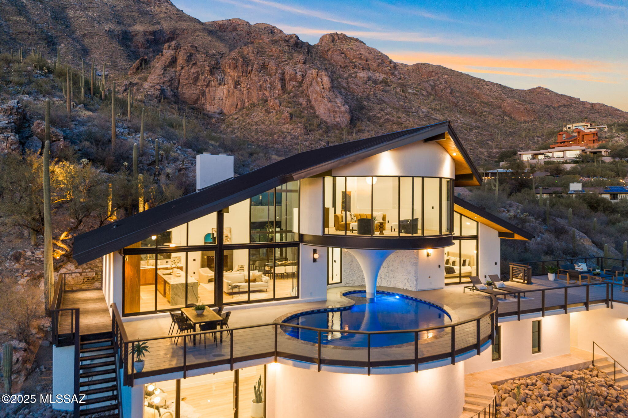 Perched high atop the prestigious, guard-gated enclave of Skyline Country Club, Martini Manor is a one-of-a-kind crown jewel that blends the golden glamour of Old Hollywood with today's most refined luxuries. A nod to the Rat Pack's timeless allure, this bespoke residence—meticulously reimagined by Vivid Home Company and Elevated Interiors—evokes the effortless elegance of Frank, Dean, and Sammy's heyday, while offering an unmatched lifestyle experience for the modern connoisseur.
From the moment you arrive at the private cul-de-sac lot, framed by dramatic desert topography and the soaring Santa Catalina Mountains, you're transported to a world of elevated living. Signature curb appeal, inspired by mid-century sophistication, is met with breathtaking natural beauty—a harmony