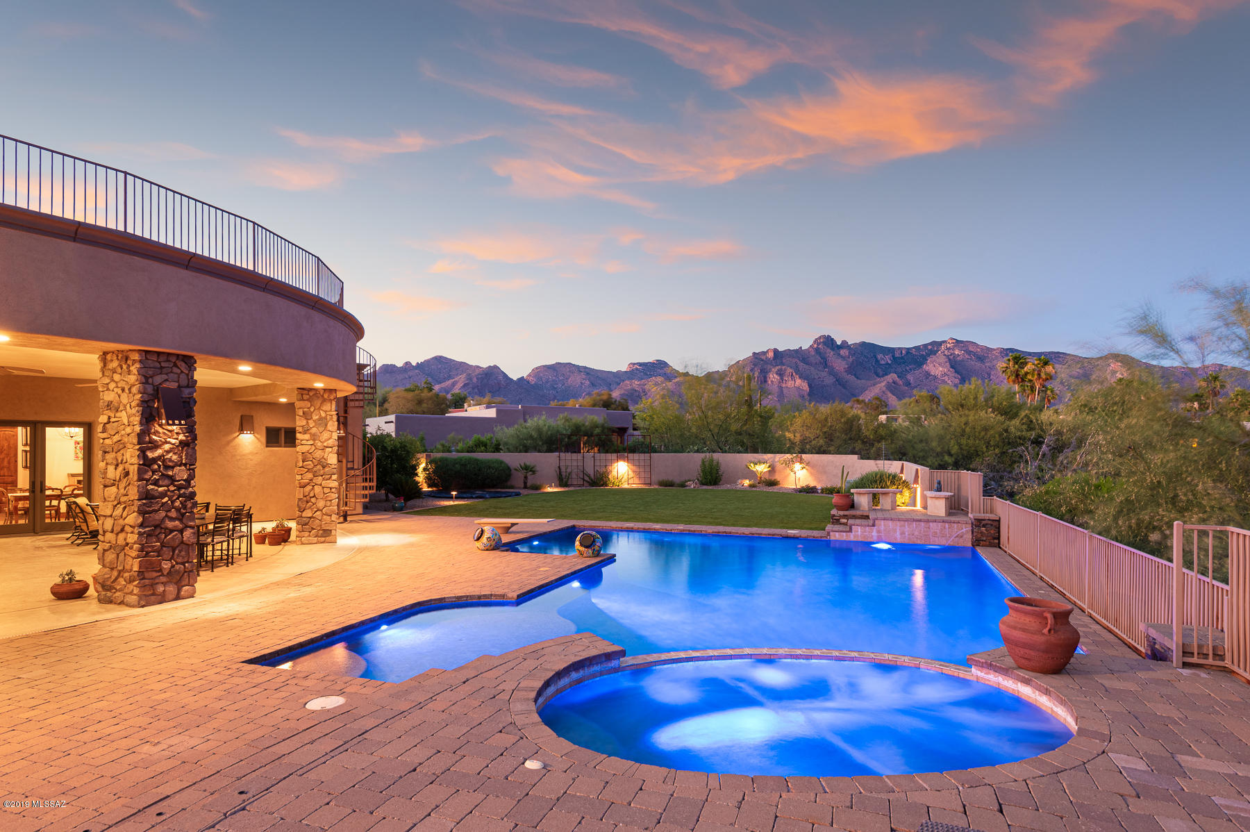 Range Price $999,900-$1,025,000Stunning Mtn Views from this Gorgeous 2008 Shadow Hills Custom Home, built w/ Family & Friends in Mind. 4 bd + Den, 5 BA & 370 sf Bonus Studio w/ Heating+Cooling.  4391 SF of Luxury Finishes: Travertine, Knotty Alder Wood, Custom Iron Door & Upgraded Lighting, Fixtures & Hardware.  Soaring 12 Foot Ceilings thruout this Bright & Open Home. Huge Great Room w/ Fireplace. Cozy Study/Office off Great Rm. Luxury Kitchen w/ Center Island w/ Prep Sink, Two Stainless Steel Dishwashers, Dbl. Ovens, Large Walk-in Pantry & Bright Breakfast Area. Formal Dining is Adjacent to Kitchen & Great Rm.  Four En-Suite BD's & Each w/ it's Own Walk-in Closet. Spectacular Master Suite w/  Jetted tub, Steam Shower, Walk-in Closet, Double Sided FP & a Private Entrance to Pvt. Patio. Studio is perfect for Artist, Workout Room, Etc. Backyard is an Entertainer's Dream w/ Mtn Views, Pool, Spa, Deep Covered Patio, Rooftop Deck, Outdoor Kitchen/Fireplace, Fruit Trees & Large Area of Low Care Turf. Enjoy an Indoor/Outdoor Lifestyle Tucson Offers to the Fullest. Surround Sound, Smart Wiring, Intercom & Alarm System. Spacious 3-Car Garage. Located within Minutes of La Encantada, Tucson's Best Restaurants/Shopping & World Class Golf Resorts.
