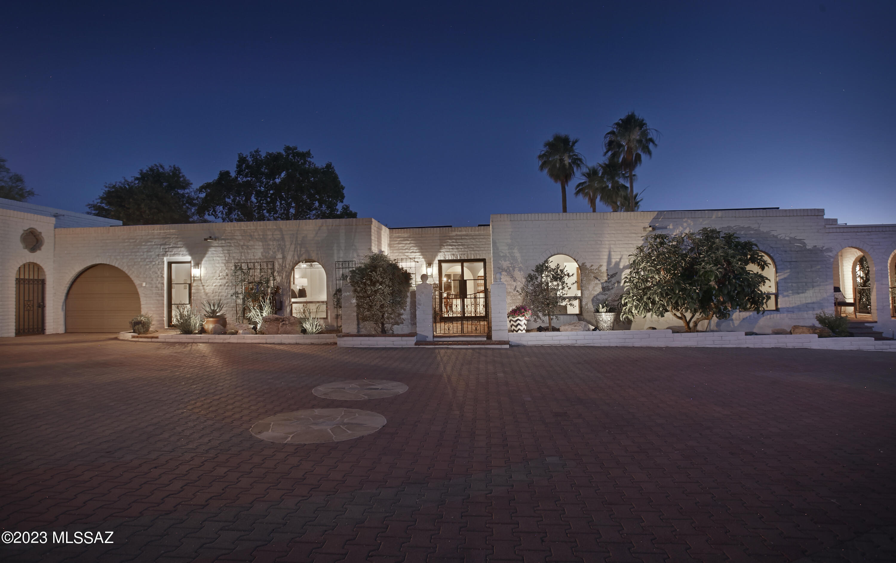 An incredible opportunity awaits in the coveted Catalina Foothills! This meticulously renovated 5 Bed/4 Bath estate, remodeled to perfection, presents an unparalleled level of comfort and sophistication. Boasting breathtaking city and mountain views, this residence offers an oasis of tranquility in a desirable Foothills location near Tucson's most exclusive shopping, dining, galleries, and Country Clubs. Updates abound in this remarkable home, including new HVAC, new plumbing, new premium water filtration system, new instant hot water, new interior doors and windows, and new sewer line with 50-year warranty. Step inside the new custom glass and metal entry doors to be welcomed by an open floor plan with walls of windows showcasing city views. The polished concrete floors exude modern elegance and timeless appeal. The kitchen, equipped with top-of-the-line appliances, quartz countertops, and large island, is open to the family room with pool views, while a butler's pantry boasts an additional oven, sink, dishwasher, storage, and convenient hookups for a supplemental washer and dryer. The impressive owners' suite features a gas fireplace, 2 walk-in closets, and home gym. This stunning property also features a charming 1 Bedroom Casita with a private patio and fountain that will surely enchant your guests, or use it as studio or office space.  The backyard is an entertainer's dream with a covered patio, artificial turf putting green, pebbletec pool and spa, and a built-in BBQ area for outdoor gatherings - all complemented by magnificent city views. The expansive garages will delight car enthusiasts with ample space to accommodate 6 cars, plus workshop, engine hoist and room for 2 lifts. Owned solar panels ensure low electric bills, and a water harvesting cistern system contribute to the property's eco-friendliness and cost efficiency. This exquisite property has been thoughtfully improved and meticulously maintained, offering a turnkey solution for those seeking the epitome of the luxury desert lifestyle. With a voluntary HOA and the impressive host of recent enhancements, this home presents an outstanding value proposition. Don't miss this opportunity to own a piece of Catalina Foothills paradise at a new attractive list price. Contact us today for a private tour and see the full list of recent improvements that make this property an unparalleled gem in this prestigious area.