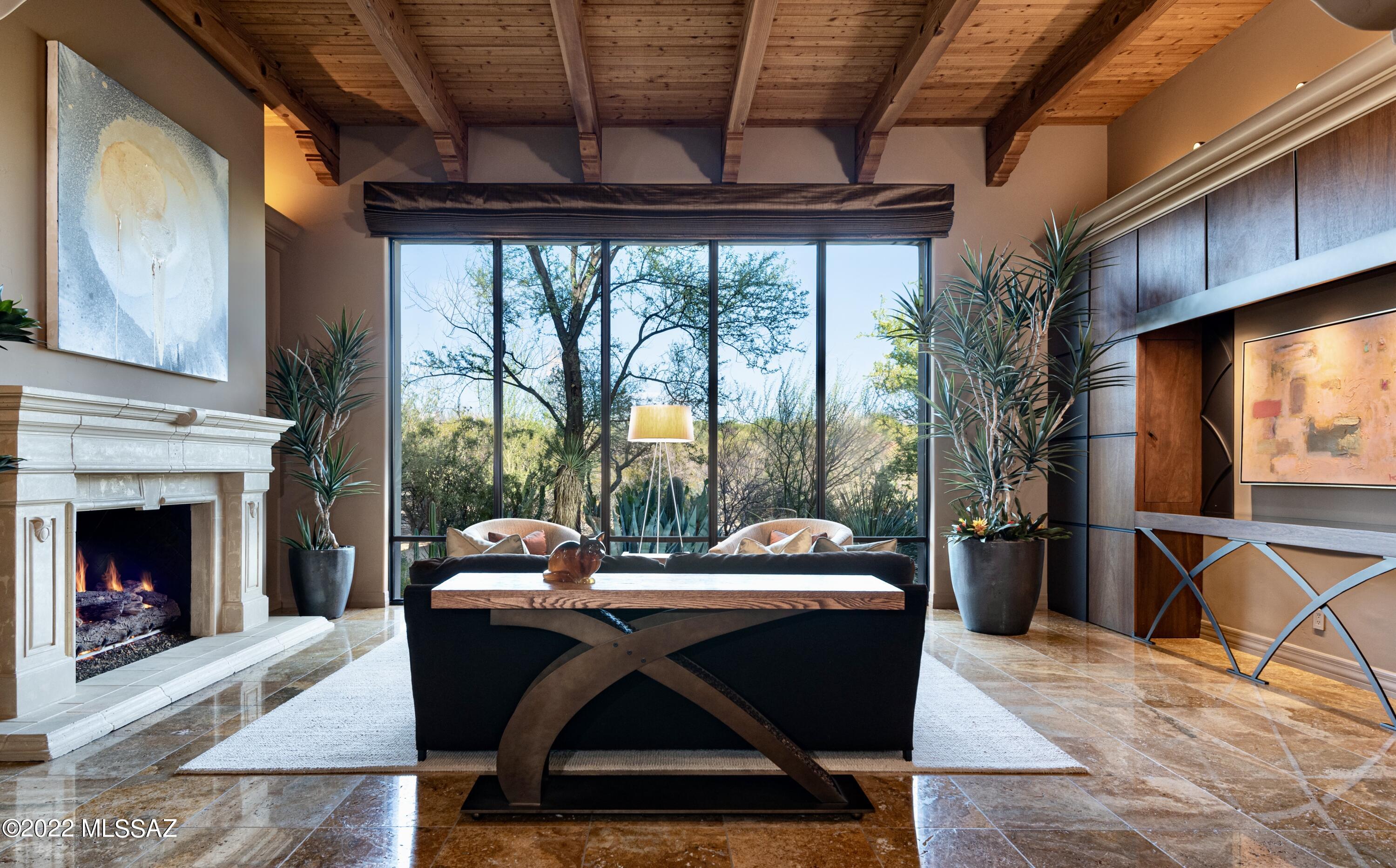 Be the beneficiary of living in this masterful custom home designed by award winning Architect, Ron Robinette. This solid integra block masonry courtyard home is adorned with the finest, timeless upscale finishes by Tucson's acclaimed artisans. Tucked within a cul-de-sac, w/i a gated community, there's a contemporary gallery-like vibe w/ warm finishes. Features: Newly a remodeled chef's kitchen, split floor plan, raised ceilings w/ wood beams/tongue & groove, plaster interior walls, air-scrubber house purifier, custom display walls, custom light fixtures, enclosed courtyard oasis, 3 car garage w/ wall separating 1 bay. Versatile indoor/outdoor professionally designed living spaces, ''A+'' cacti specimens. No steps. Great cycling, walking & bird/nature watching
