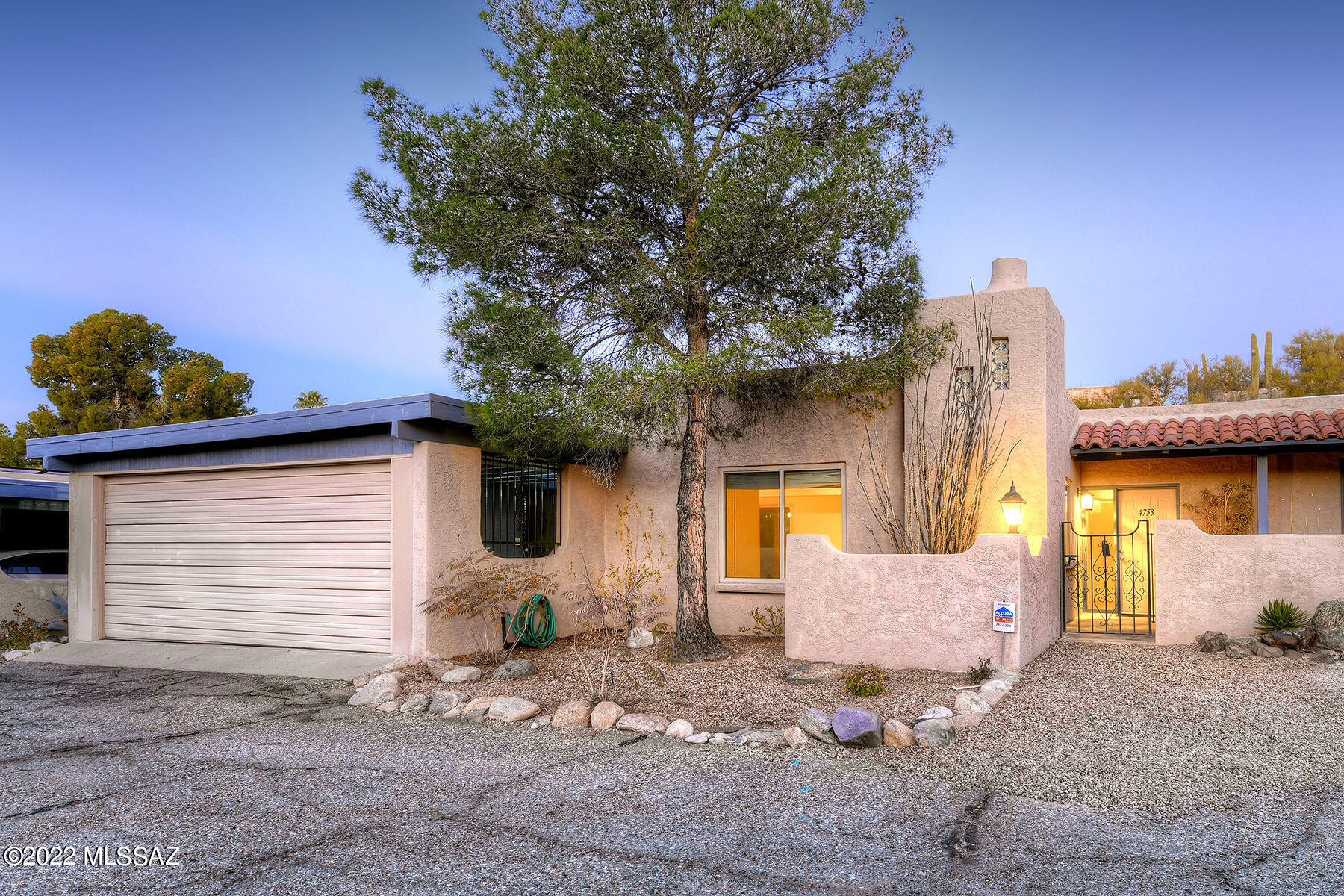Calle Lampara is perfectly located in the lower central Catalina Foothills.  Walk to the Heirloom Farmers Market, the Rillito River Walk, St Philips Plaza, restaurants and more!  This beautiful 2 bedroom 2 full bathroom home is ready to move in!  Bright and open floor plan has a corner fireplace, ceramic title floors throughout the living areas and walk ways.  Dual pane windows & Solar panels!  Kitchen has Corian counter tops, newer stainless steel appliances and a breakfast bar.  The primary bedroom has generous walk in closet and ensuite bathroom.  Every room in this bright house opens with glass doors to the back yard with wrap around covered patio, brick pavers, garden plantings, trees. Peaceful, private, and so charming! New H20 heater in 2021.  2 car garage!