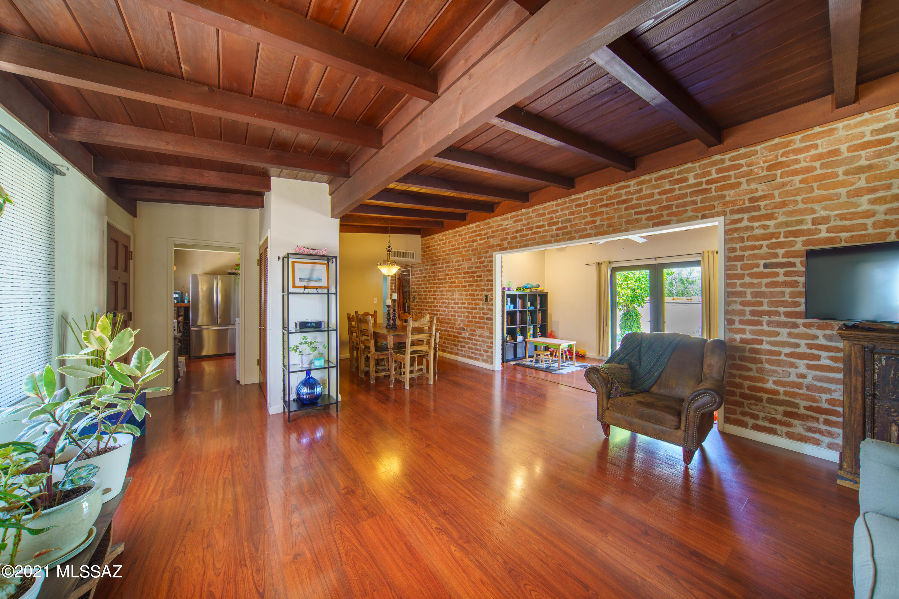 Impressive Burnt Adobe home with stately beam ceilings and views of Tumamoc on spacious .18 acre lot. Beautifully updated and maintained. Very Versatile floorplan. AZ room can be play room, office, pool table room, or formal dining room. Dining area can also be sitting area or office. Room currently used as pantry/storage room can be office or possible 3rd bedroom. No Carpet. Spectacular 4th of July views of A mountain fireworks. RV space available. Explore thriving Downtown Tucson, Climb popular Tumamoc Hill or visit Mercado San Augstin with charming eateries, shops, farmers markets and events just minutes away. Back lot is much larger than it appears; block wall does not encompass all of the property, property goes to alley. NO HOA. Please do not Disturb Tenants without an appointment.