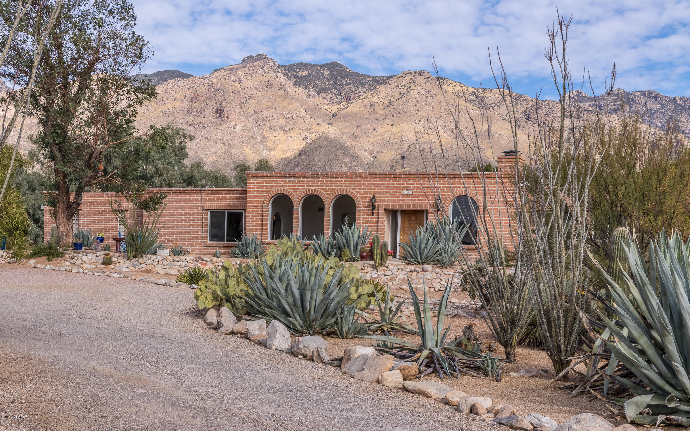 Come see this wonderful burnt adobe home with Catalina Mountain views set back on a flat, almost-acre lot in Skyline Bel Air Estates. It's a very solid house with a great feel to it. Enjoy a beautifully-updated kitchen with extra thoughtful storage and touches any cook will appreciate. All four baths have been updated, complete with granite countertops. You will be party-ready with big living and dining rooms, resort-like backyard and ample off-street parking. Most of the windows are newer and dual-pane. New 16-SEER HVAC in Dec 2016. Oversized two-car garage with big storage closet. Storage shed stays.