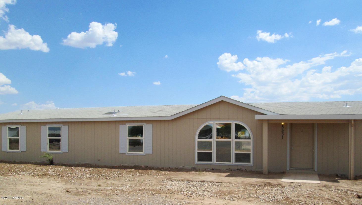 No need to look any further! Just unpack and relax in your move-in ready home with a fenced yard and large double gate making access to the backyard easy! Double carport! Covered patio to enjoy the beautiful starry desert nights! Giant wraparound kitchen opens into a bright breakfast area with sliding glass door to the backyard. Separate living room & family room with a cozy fireplace. Extra storage room/workshop with electric is perfect for the hobbyist!