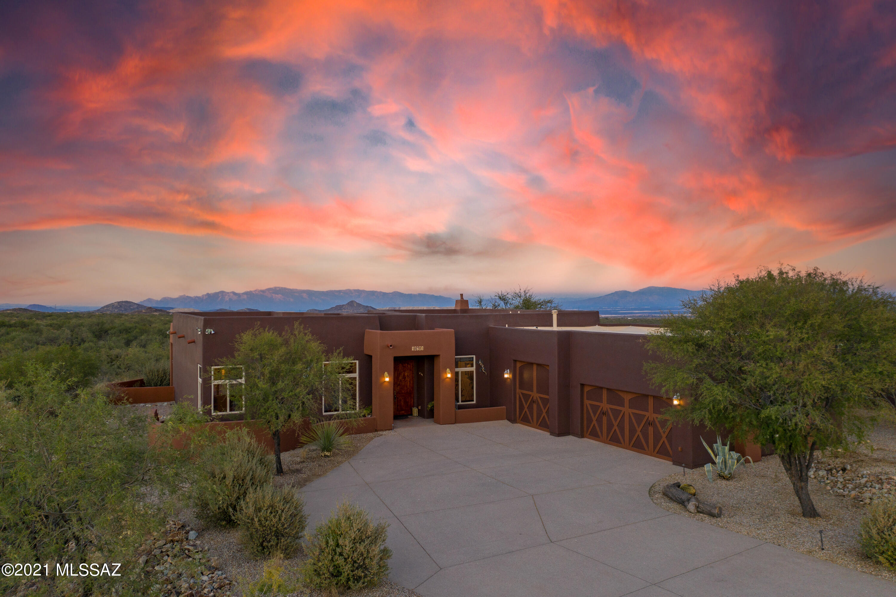 This stunning custom estate is perched high on a 15.97-acre premium lot surrounded by breathtaking views of the Sierrita Mountains.  Situated within the gated community of Ruby Star Airpark, a world-class airpark that caters to equestrian and aviation enthusiasts.  The Airpark features stunning views of the mountain ranges to the west and east, as well as mesmerizing sunsets, spectacular sunrises, and is surrounded by thousands of acres of State Land. No custom details were overlooked in this immaculate home, from upgraded Jenn-Air luxury appliances, custom fixtures, 10' ceilings, and extensive profile 8'solid alder wood doors with custom hardware. The kitchen features large modern concrete countertops; appliances include an electric cooktop, pop-up ventilation, and double ovens. The Primary Suite includes a large jetted soaking tub, stone-tiled walk-in shower, concrete counters, stunning copper sinks, and custom cabinetry throughout.  Three additional private bedrooms with the split bedroom plan complete with full bath & 3rd bath off the hall. Massive Airplane Hangar is approximately 2,800 sqft with a custom paver driveway and equipped with living quarters. Convienitly located near the Airpark's 4,300-foot asphalt runway for easy taxiways. Luxury & tranquility blended seamlessly between indoor living and an outdoor lifestyle. Your new home awaits!