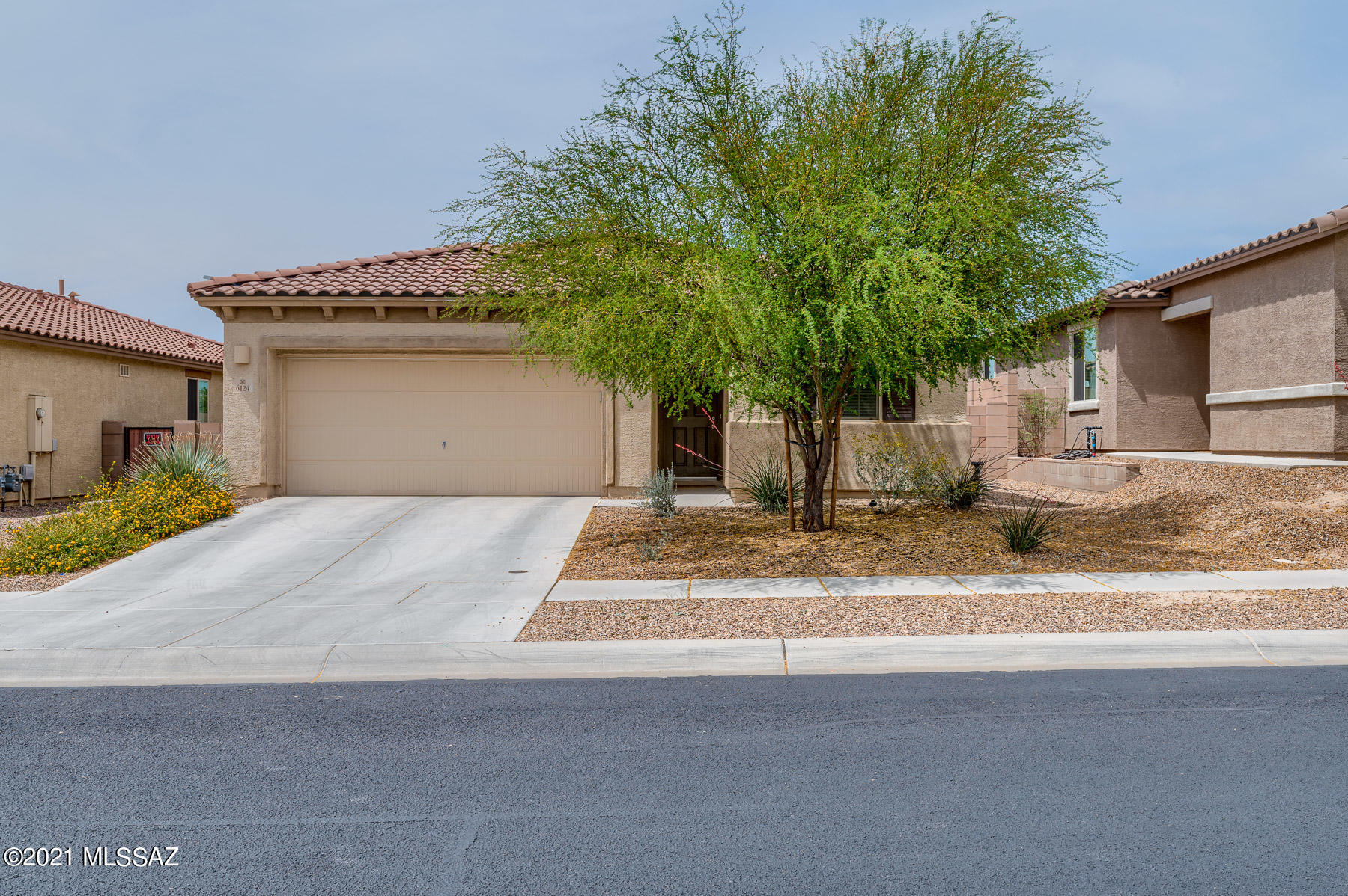 Check out this NW gem! It's perfectly located near the Tucson Premium Outlets, I-10 and other nearby shopping, restaurants, emergency center and golf. All the right builder kitchen upgrades to include granite, upgraded cabinets, custom backsplash, exhaust hood, walk-in pantry and deep undermount single basin sink. Nice backyard customized with pavers, artificial grass and lights. Tile throughout with carpet in bedrooms. You'll love the home's details like the stacked stone fireplace, custom paint, double sinks in master bath, wood blinds and cabinets in the laundry room. Beautiful home waiting for it's new owners.