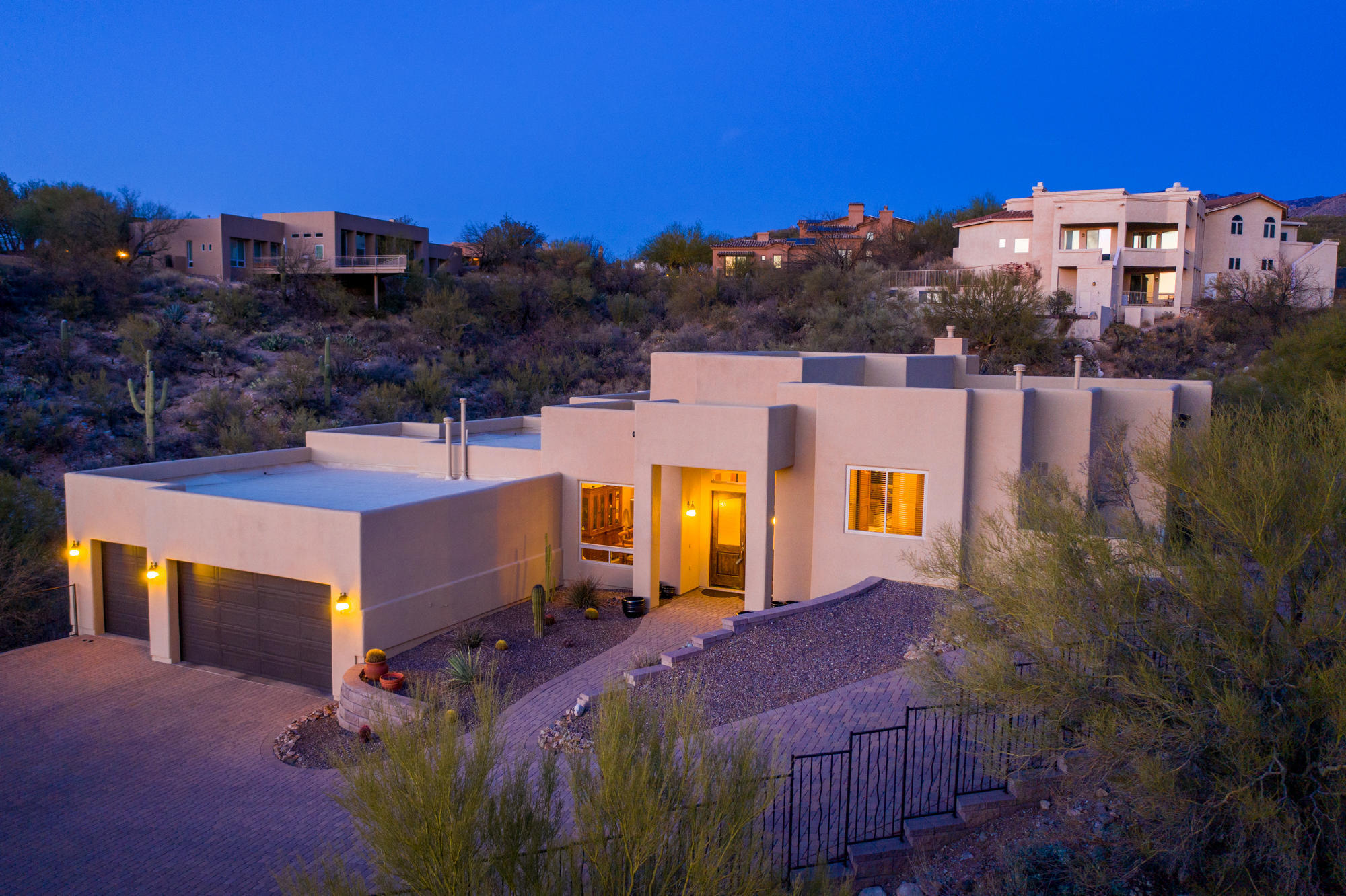 Seller to entertain/counter offers between $850k-$900k. Beautiful drive through guard-gated community in Oro Valley. This is the home you've always dreamed about; a picture-perfect showcase of natural beauty in exclusive La Reserve. This soft-contemporary beauty is nestled in the rolling hills of the Pusch Ridge Mountains in the serene Sonoran Desert with breathtaking, panoramic mountain and sunset views. Witness how the mountains change color as the sun sets and night descends. Even as you enter through the double entry doors of your home, you'll be privy to a view of the majestic saguaro mountains through a wall of glass, and it only gets better. This custom home meets the most exquisite tastes and preferences of wise buyers. Owners are related to one of the listing agents. Master craftsmanship and the finest natural materials adorn the interior with: 12'6" ceilings in great room featuring a gas fireplace accented with travertine; 18" porcelain tile; 6'8" and 8' alder hardwood interior doors throughout; designer lighting; powder room with pedestal sink accented by an abalone shell wall. This 4-bedroom, 2.5 bath, 3,084 sqft of open living on an elevated 0.74 acre lot, overlooks the peaceful natural desert with an amazing Pusch Ridge view. The Great Room is the focal point and heart of the home. It opens onto the kitchen area where a cook can create meals while entertaining guests. Kitchen Aid stainless steel appliances: granite slab counter top accented by glass tile backsplash; gas cooktop with griddle and grill; and new plumbing fixtures. The private Master Wing/Suite lends a sense of rustic romance and peaceful energy with double French doors that lead to patio with unobstructed views of Pusch Ridge; Master Bath houses spa-like features, such as his/her custom vanity with quartz counter top; therapeutic jetted tub with glass tile surround; multi head shower;  all tile work surround go to ceiling. Laundry room with custom cabinets and quartz countertops. The oversized three-car garage with epoxy floor, hi-loft storage is also something no man can ignore as the ultimate place to park a beautiful ride! What a wonderful retreat and exquisitely comfortable home to build lasting memories with family and friends!